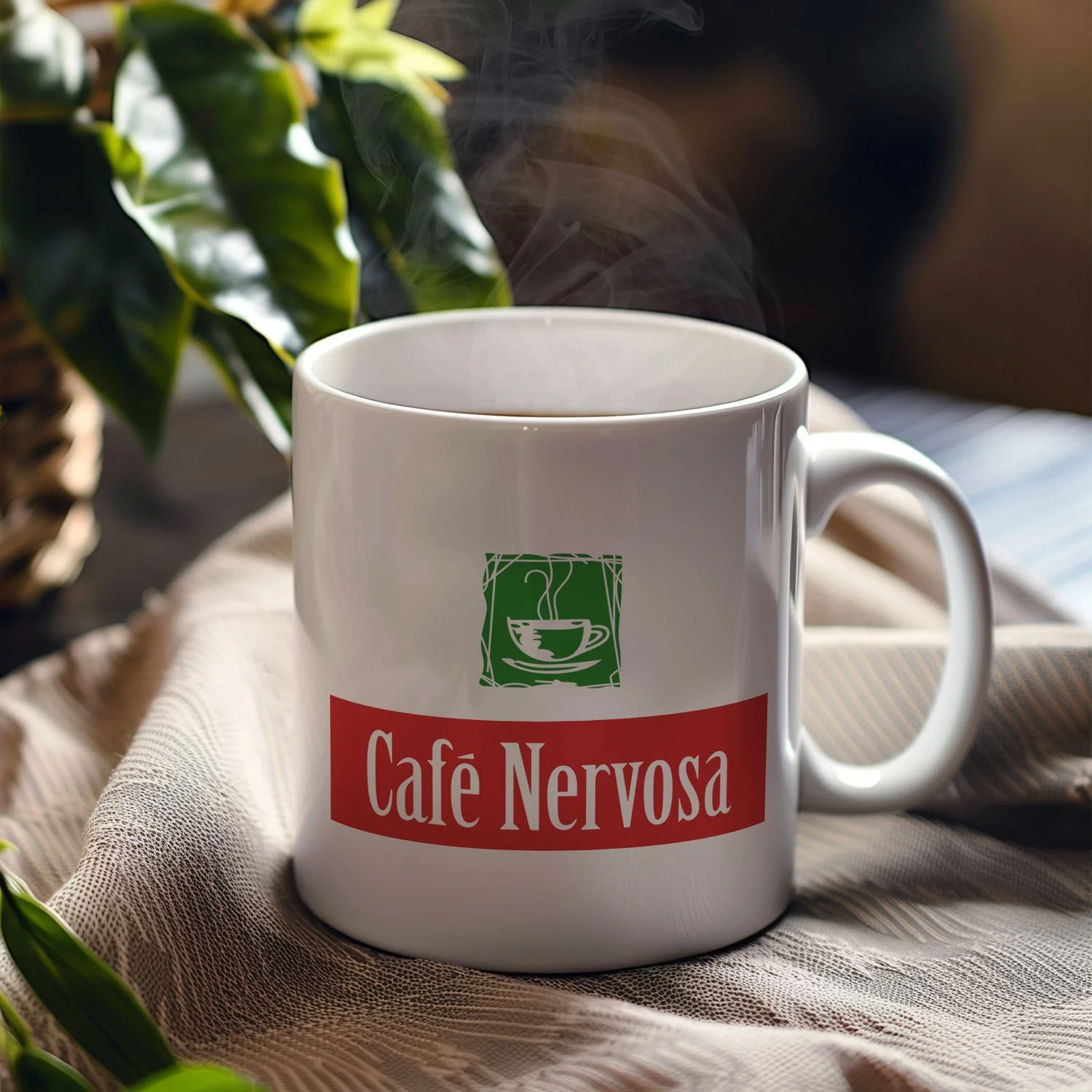 A Café Nervosa mug is displayed on a table, filled with coffee.