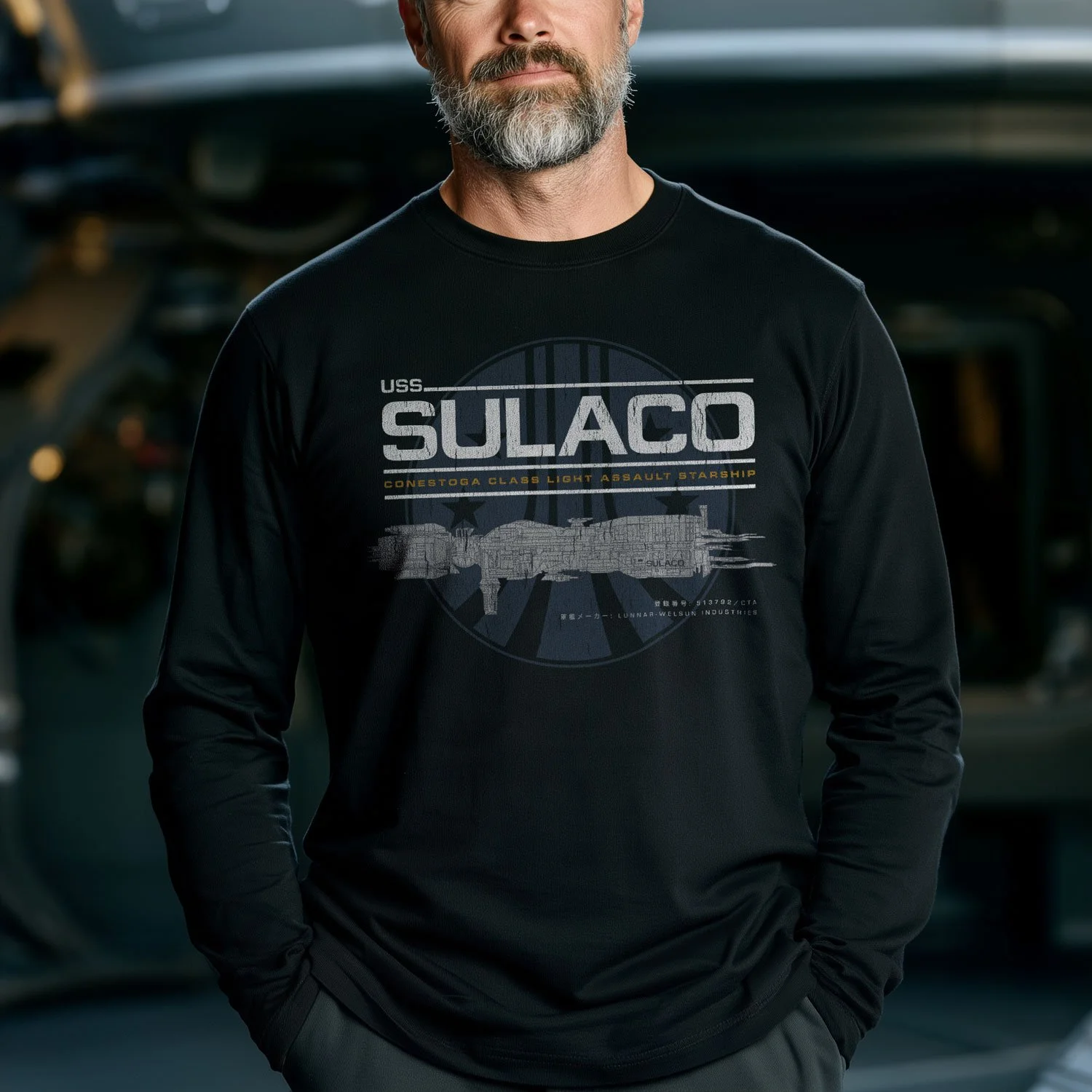 Image of a man wearing a USS Sulaco long-sleeve T-shirt inside a spaceship.