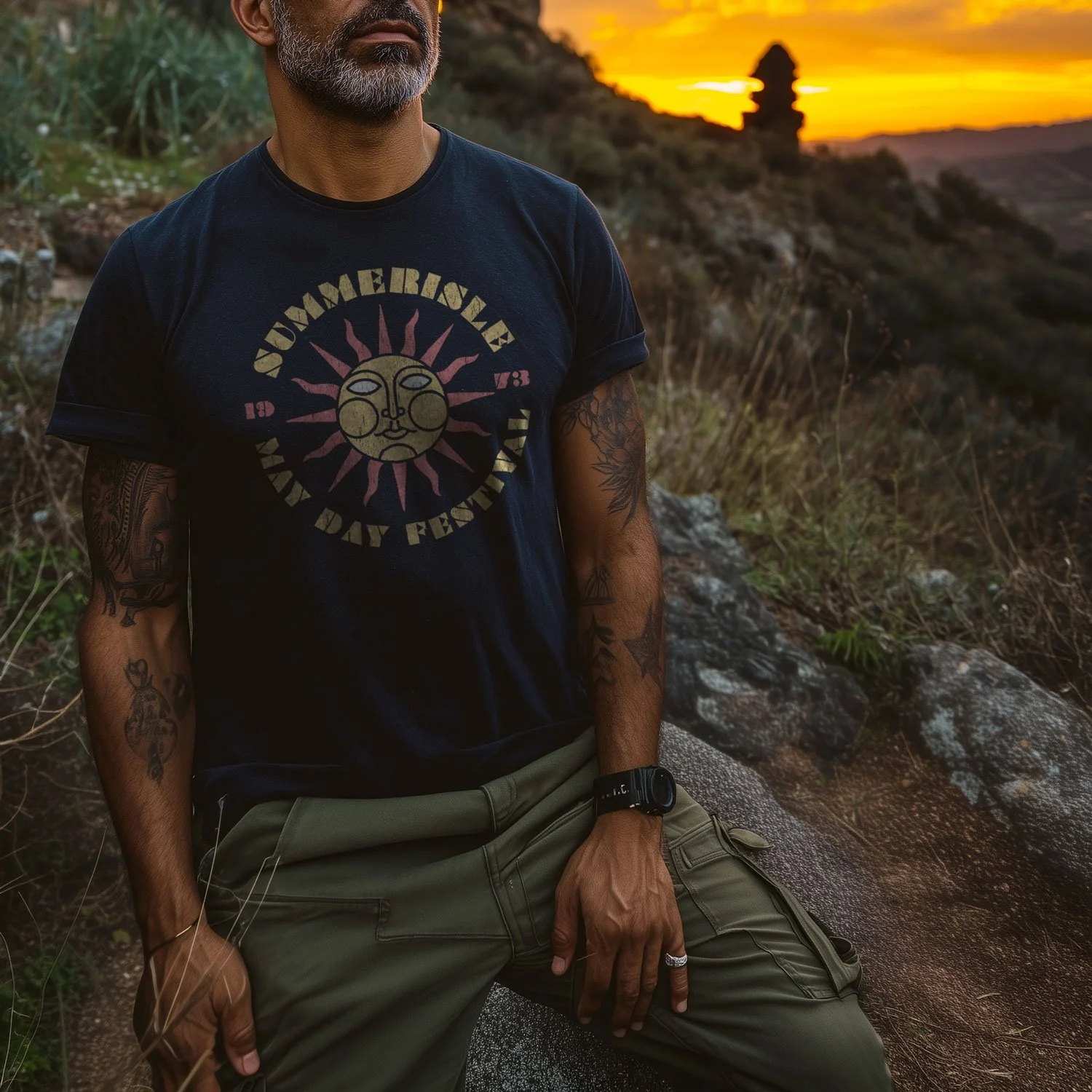 Image of a man wearing a navy blue Summerisle T-shirt in a rugged Scottish landscape.