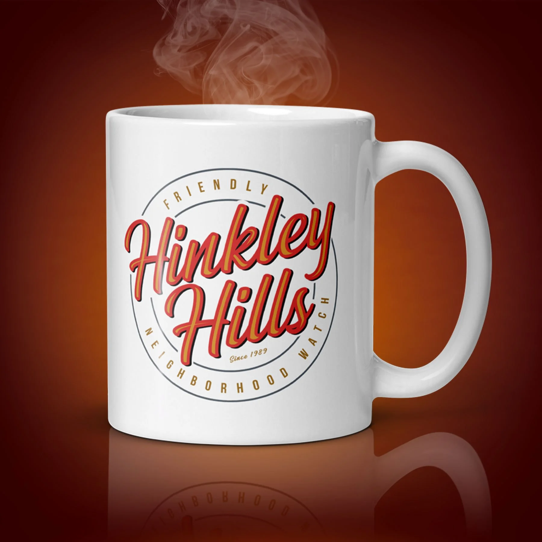 An 11-oz Hinkley Hills mug displays the left side. The artwork on our mug is inspired by the movie "The 'Burbs". It is available for $21.99 with free shipping.