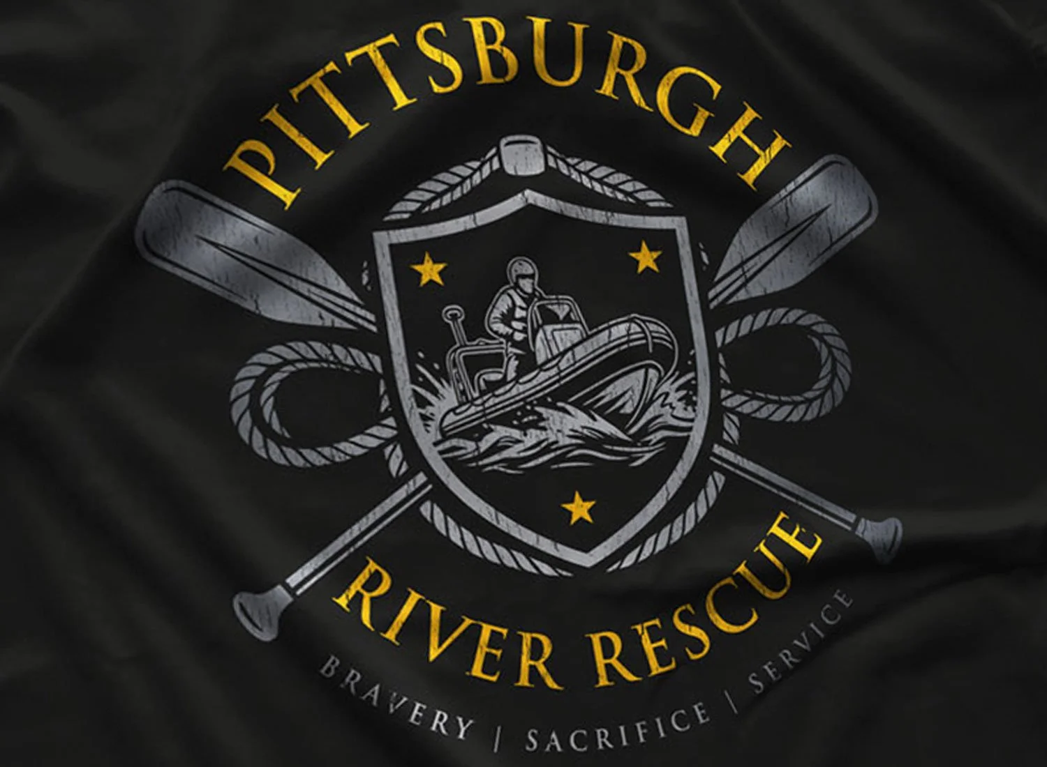 Close-up of a Pittsburgh River Rescue T-shirt in Black. Get your "Striking Distance"-inspired shirt in sizes S to 5XL, starting at just $21.49 with free shipping.