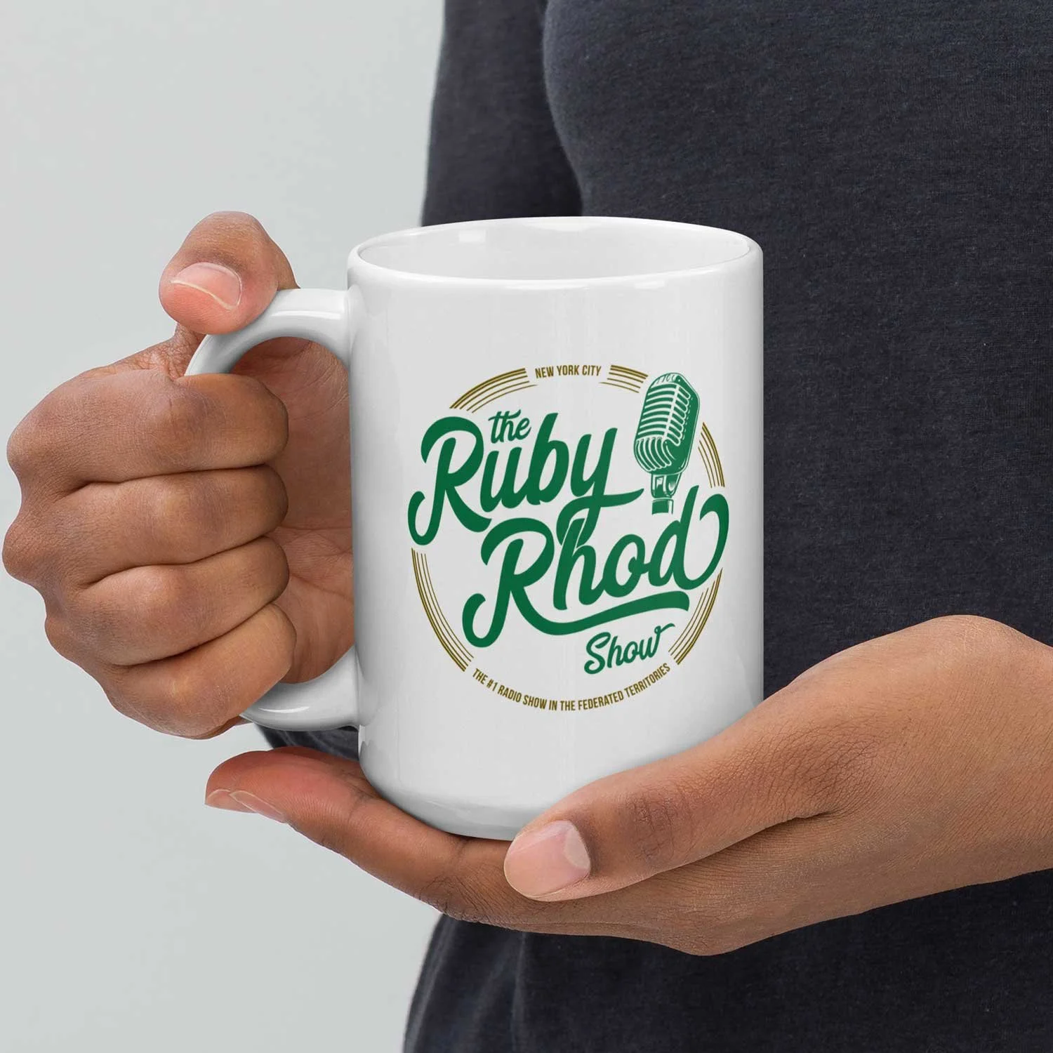 Close-up of a man holding a 15-oz The Ruby Rhod Show Mug.