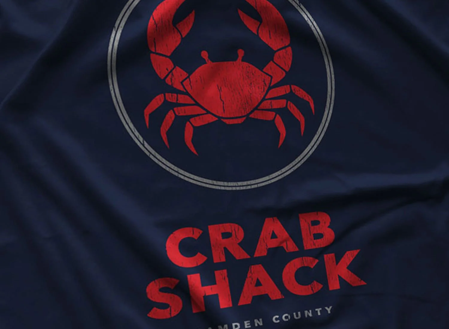 Close-up of a Crab Shack T-shirt in Navy Blue. Get your "My Name Is Earl"-inspired shirt in sizes S to 5XL, starting at just $21.49 with free shipping.