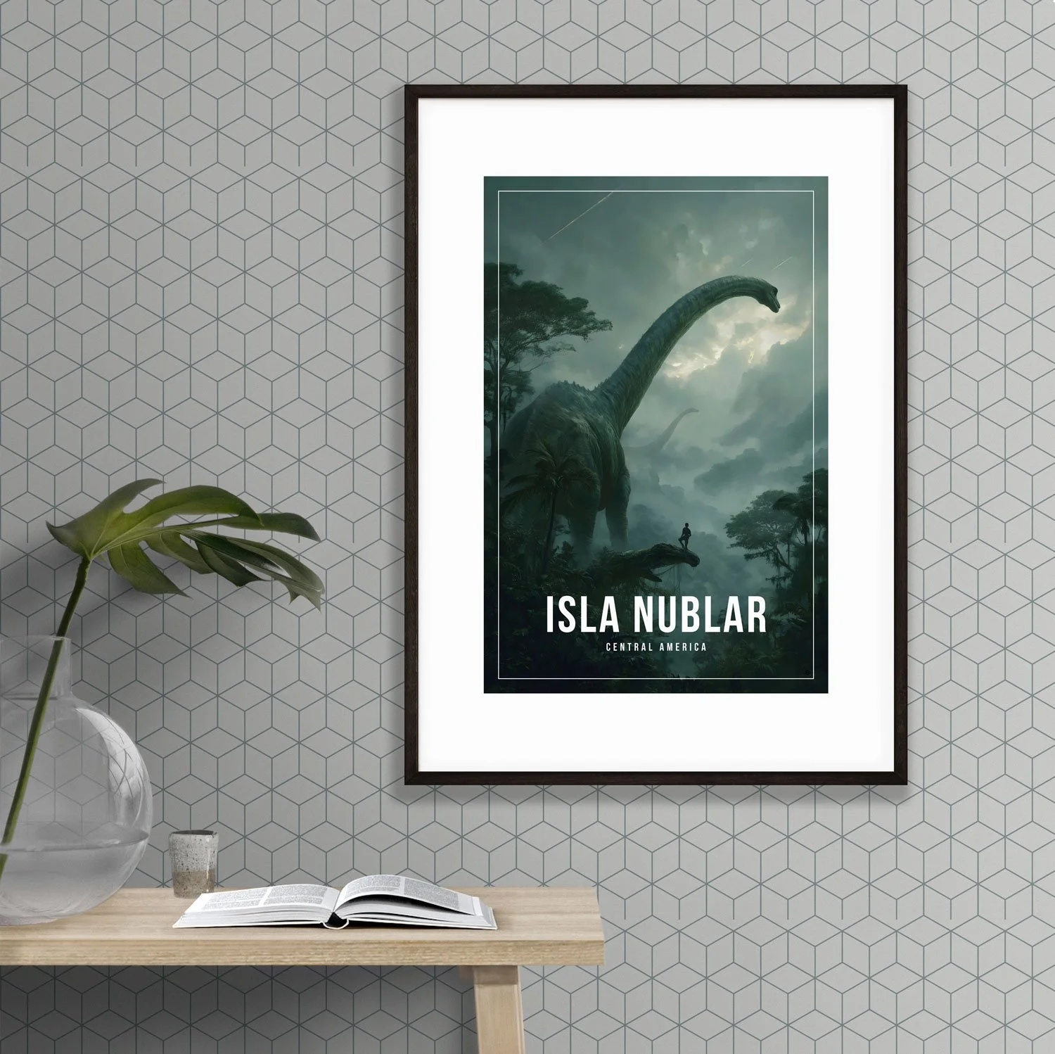 Photo of an A2 frame holding a 12x18 inches Isla Nublar poster hanging on a wall next to a table with a book and glass vase.