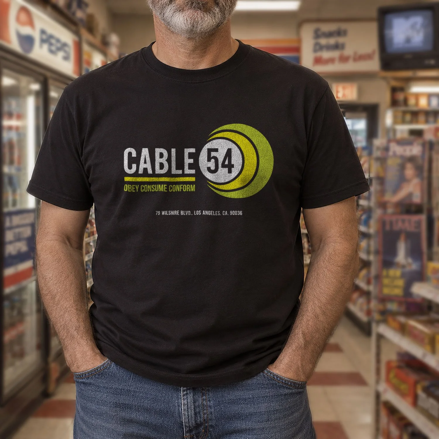Image of a man wearing a Cable 54 T-shirt in a retro 1980s convenience store.