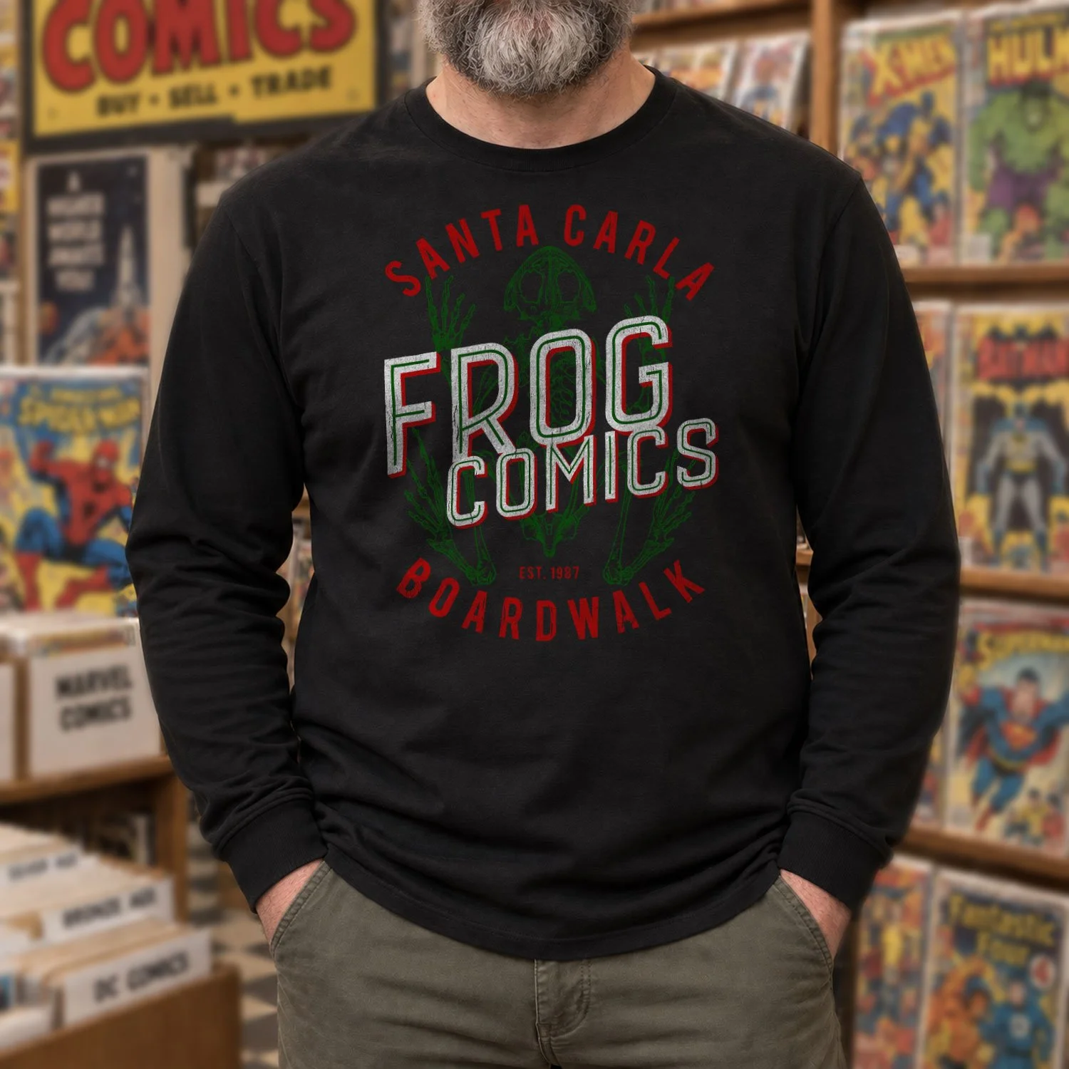 A man is wearing a Frog Comics long-sleeve T-shirt while standing in a retro comic book store.