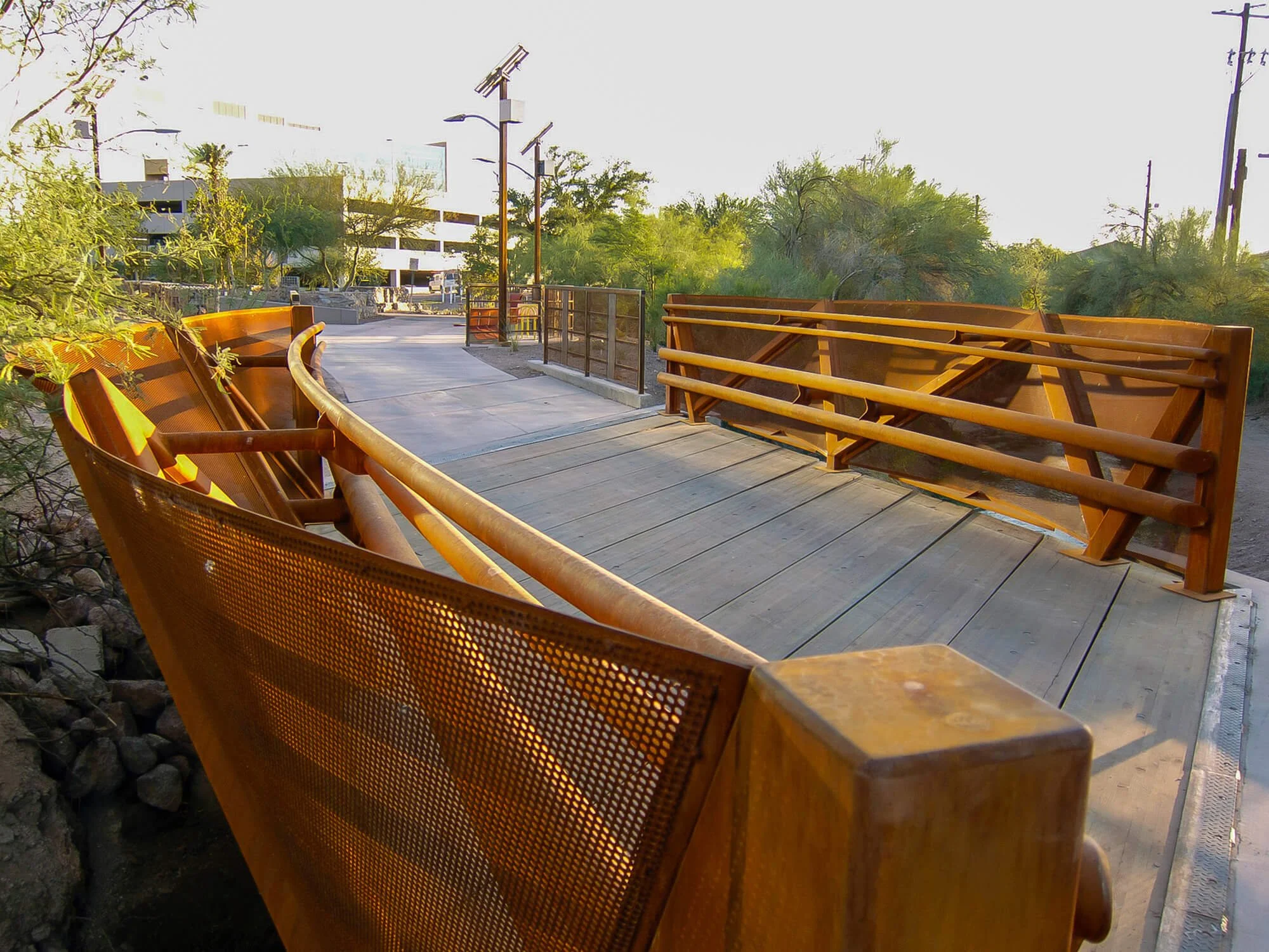 Sculptural rusted steel pedestrian bridge