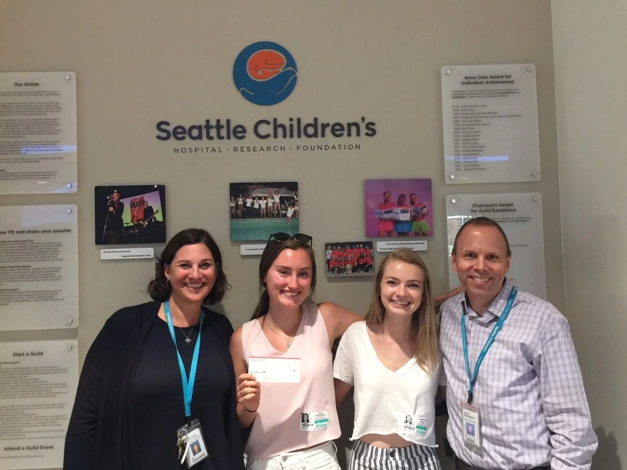 Anna presenting a check from Cross Out Cancer Seattle to Seattle Children’s Hospital