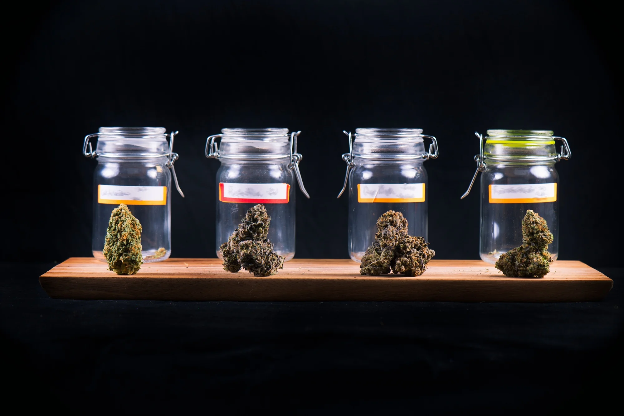 Assorted cannabis bud strains and glass jars - medical marijuana dispensary concept.jpg