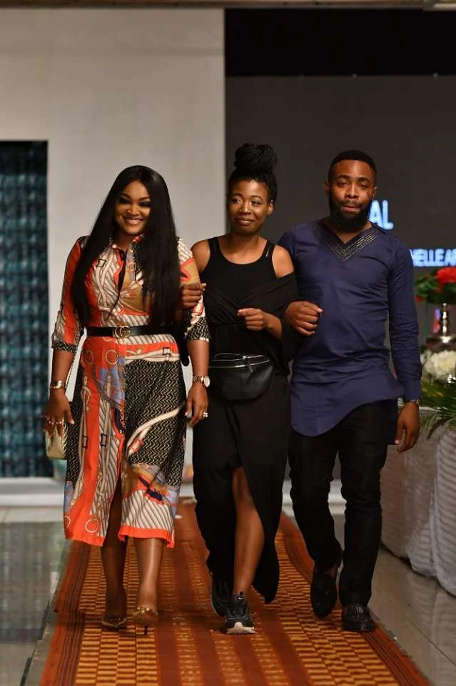 Mercy-Aigbe-and-Woli-Arole-walking-the-runway-with-Michelle-Arowoshola.jpg