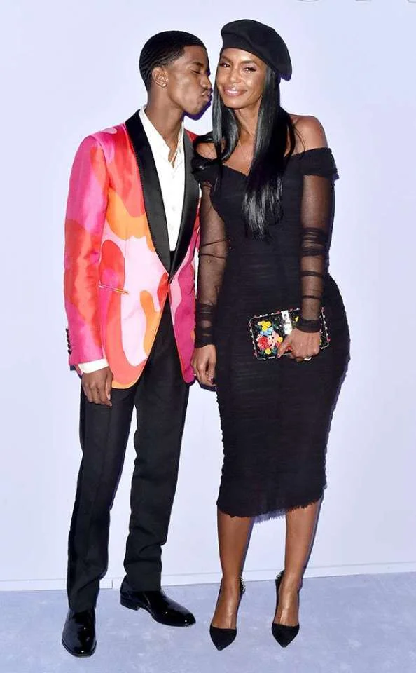Kim-Porter-and-her-son-Christian-Combs-Kim-is-wearing-a-figure-hugging-black-dress-with-sheer-sleeves-and-a-box-clutch.jpg
