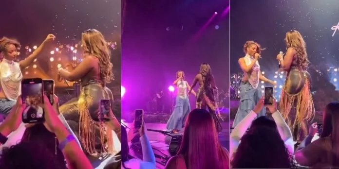Tems plays on stage alongside Ayra Star.