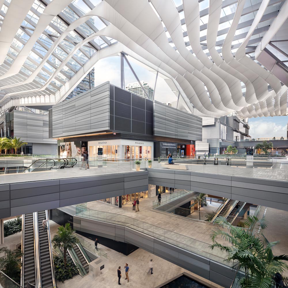 Winding through the development is the BCC Retail space, an open air mall covered by the climate ribbon, designed to move air through the building and keep it cool without the use of A/C