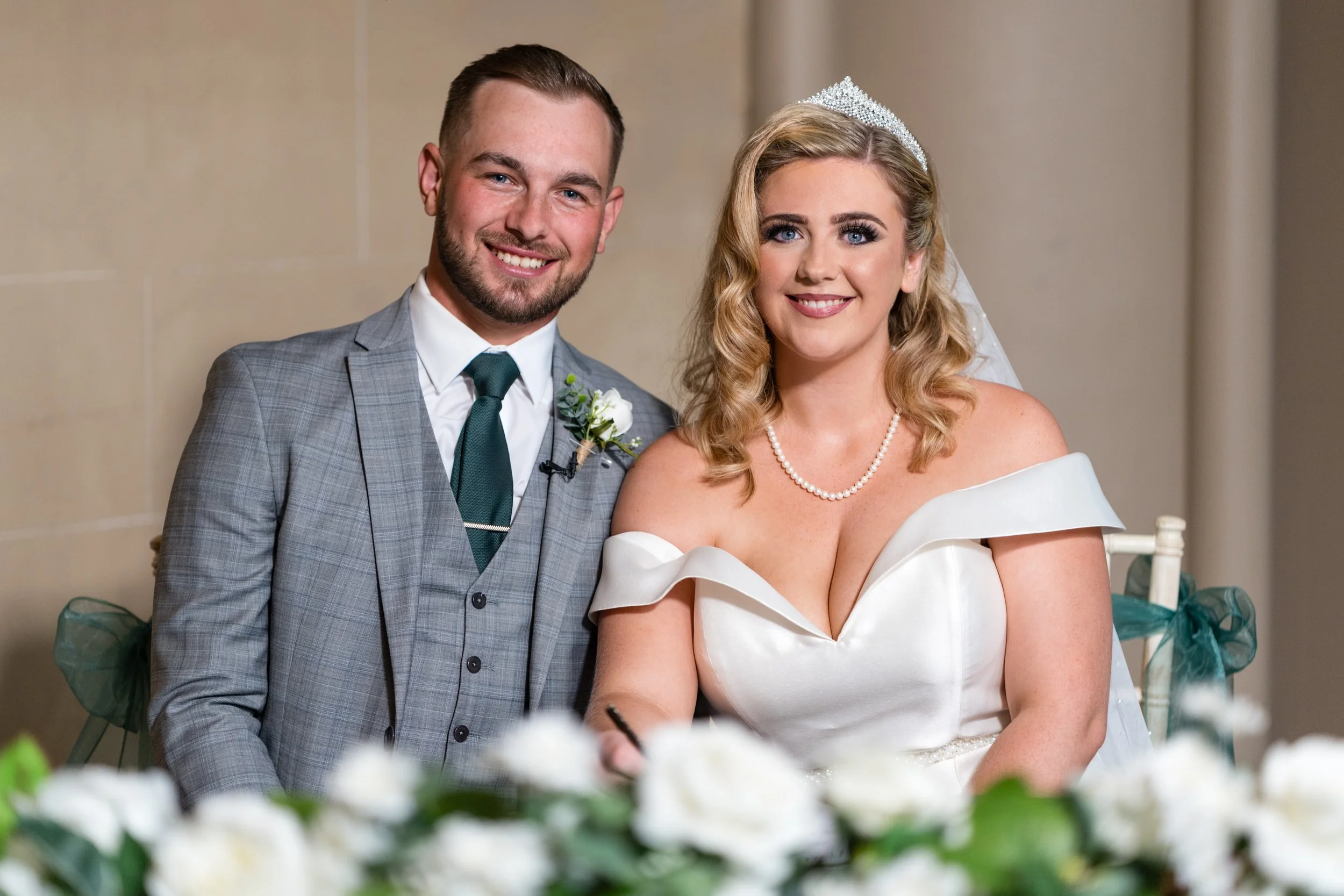 Bride &amp; Groom signing the register at Belvoir Castle