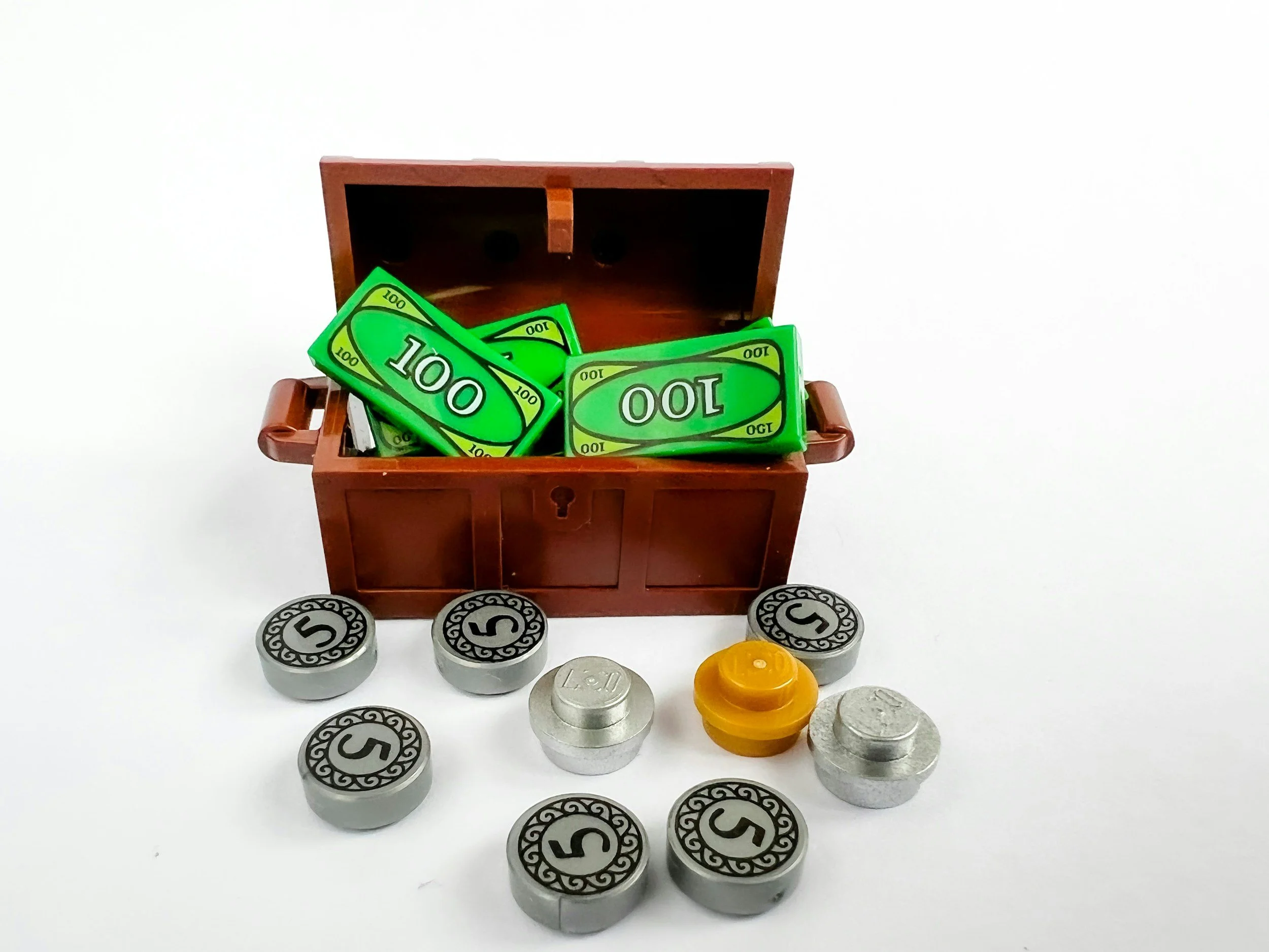 a LEGO chest filled with LEGO dollars with gold and silver LEGO coins laying in front.