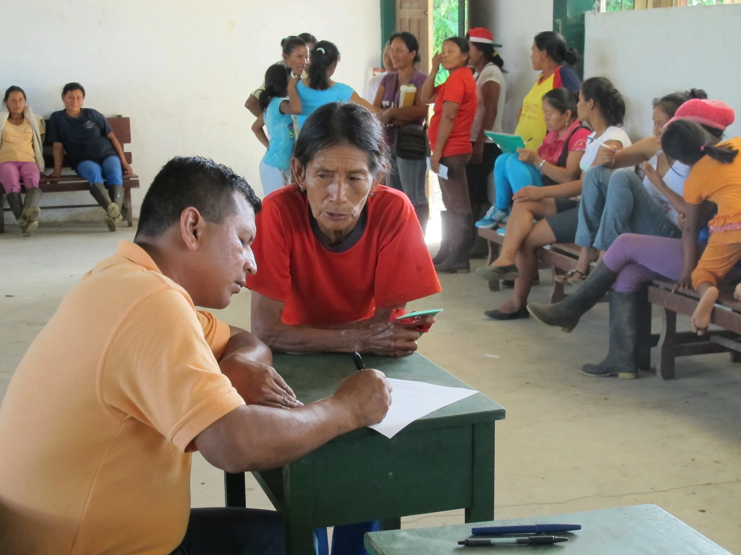 Edmund Cerda surveying Joaquina about the rainwater project. Photo by Joan Hanawi.