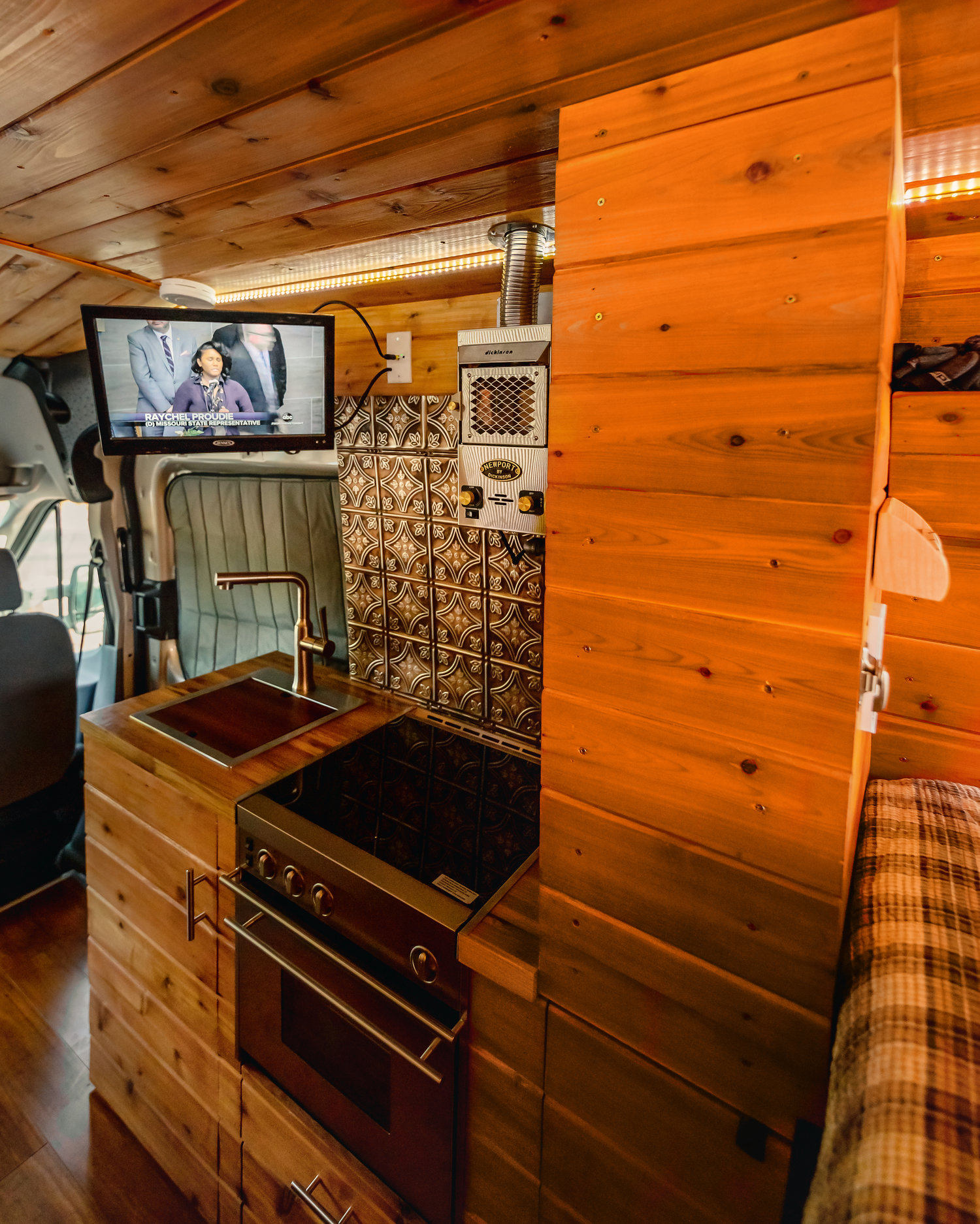 Inside the Custom Ford Camper - Tv on and the kitchen set-up