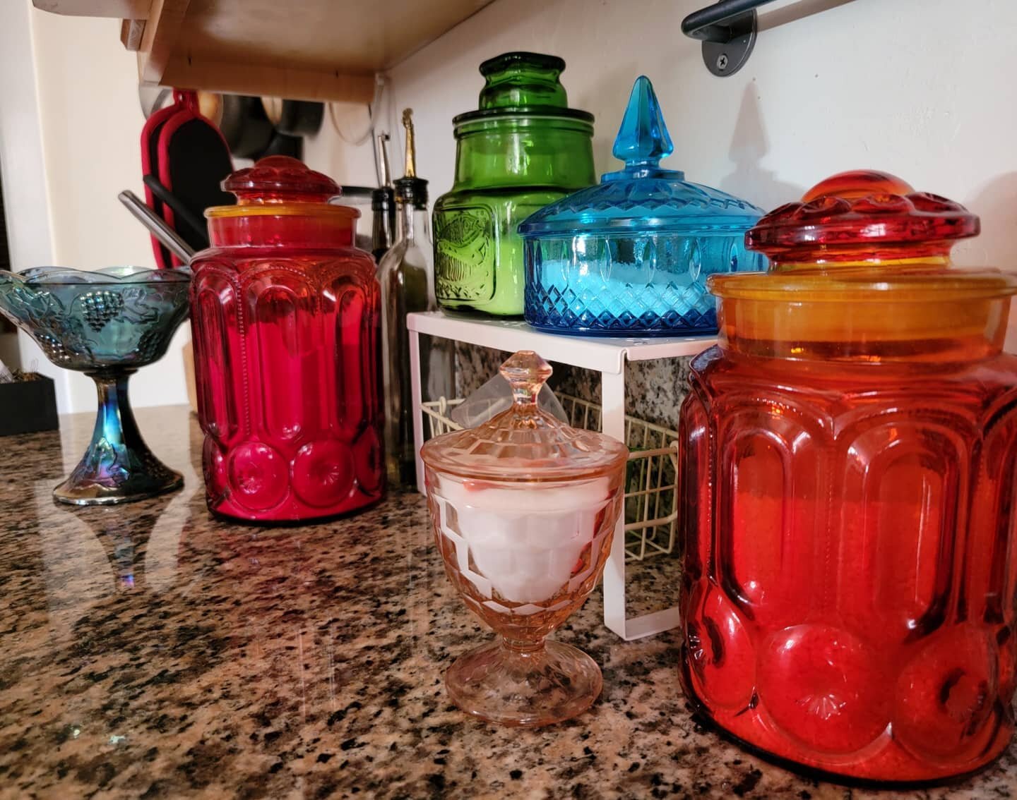My collected colored kitchen glass. Small pink is granulated salt, big red is flour, medium red is short grain white rice, green is sugar and blue is my kosher salt pig. The carnival glass bowl at the end I found at goodwill recently, it's actually a