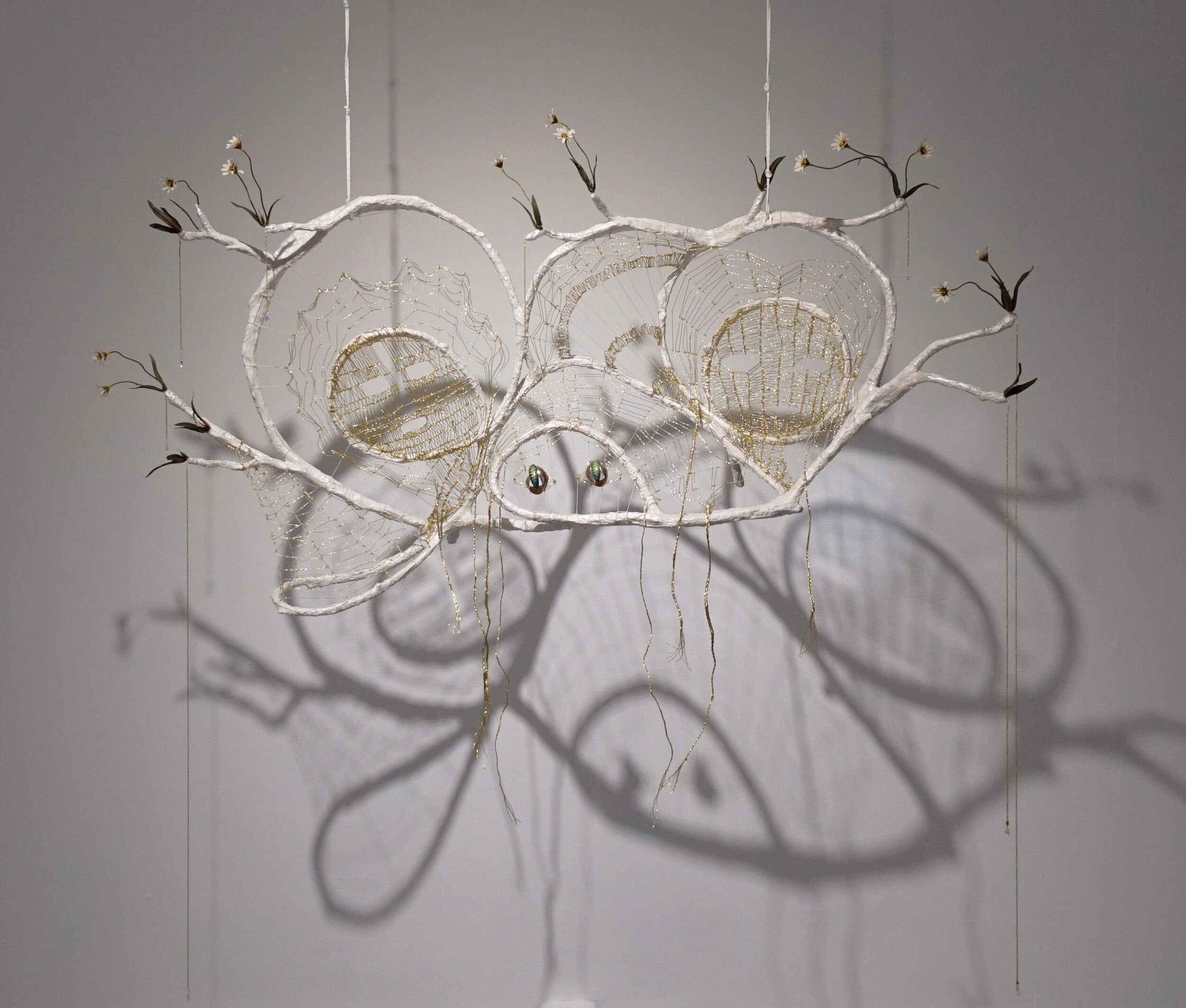  Mindy Rose Schwartz    Glance Back , 2020 Branches, reeds, wire, resin, linen cord, lamé cord, earrings, crystals, fake flowers, chain 50 x 51 x 13 in 127 x 129.5 x 33 cm 