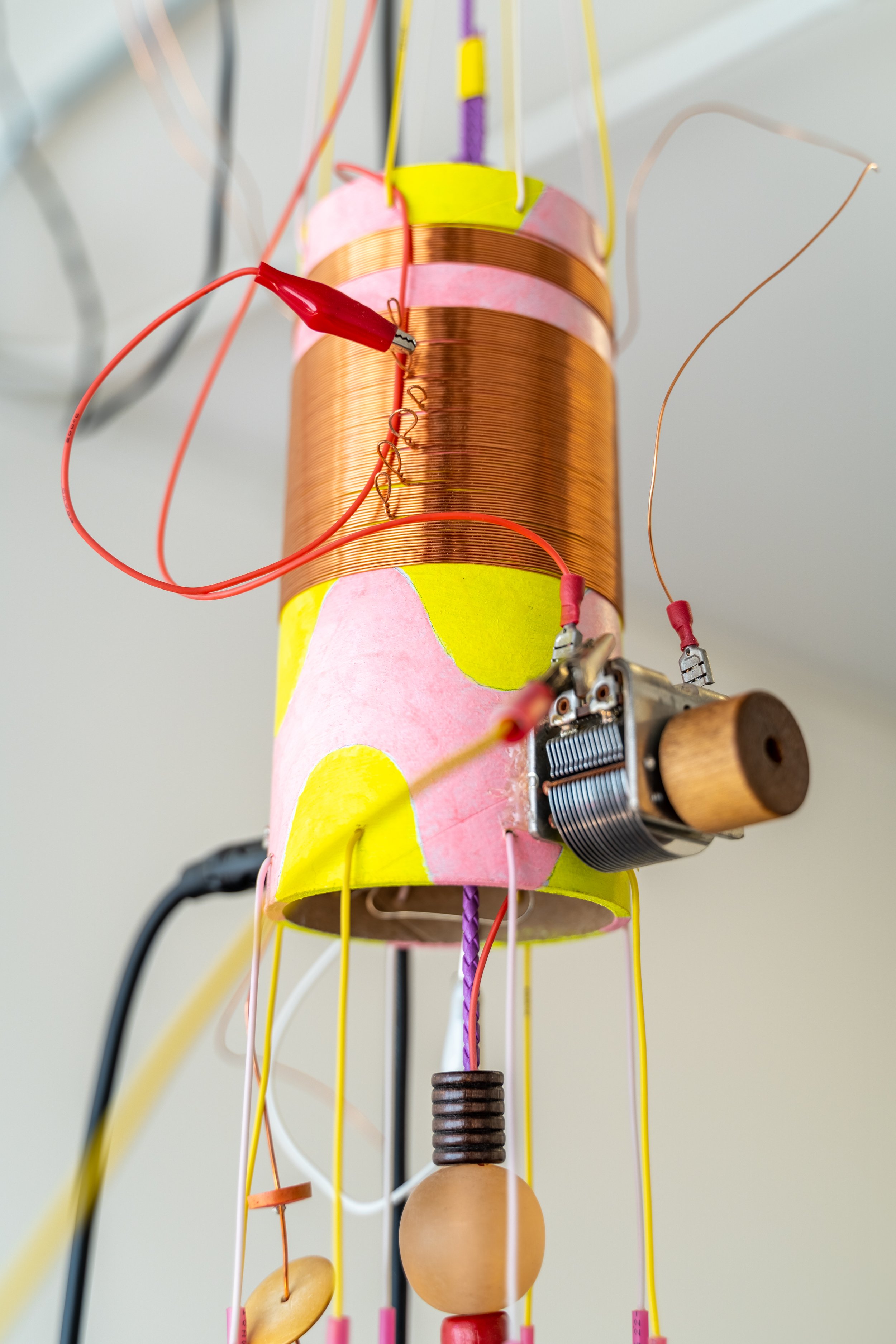  Peter Simensky  Pyrite Radio - Chimes (Yellow/Pink) , 2021 (detail) Pyrite (fool's gold), copper, electrical wires, bead work, feathers, cardboard tube, paint, amplifiers, and radio hardware 