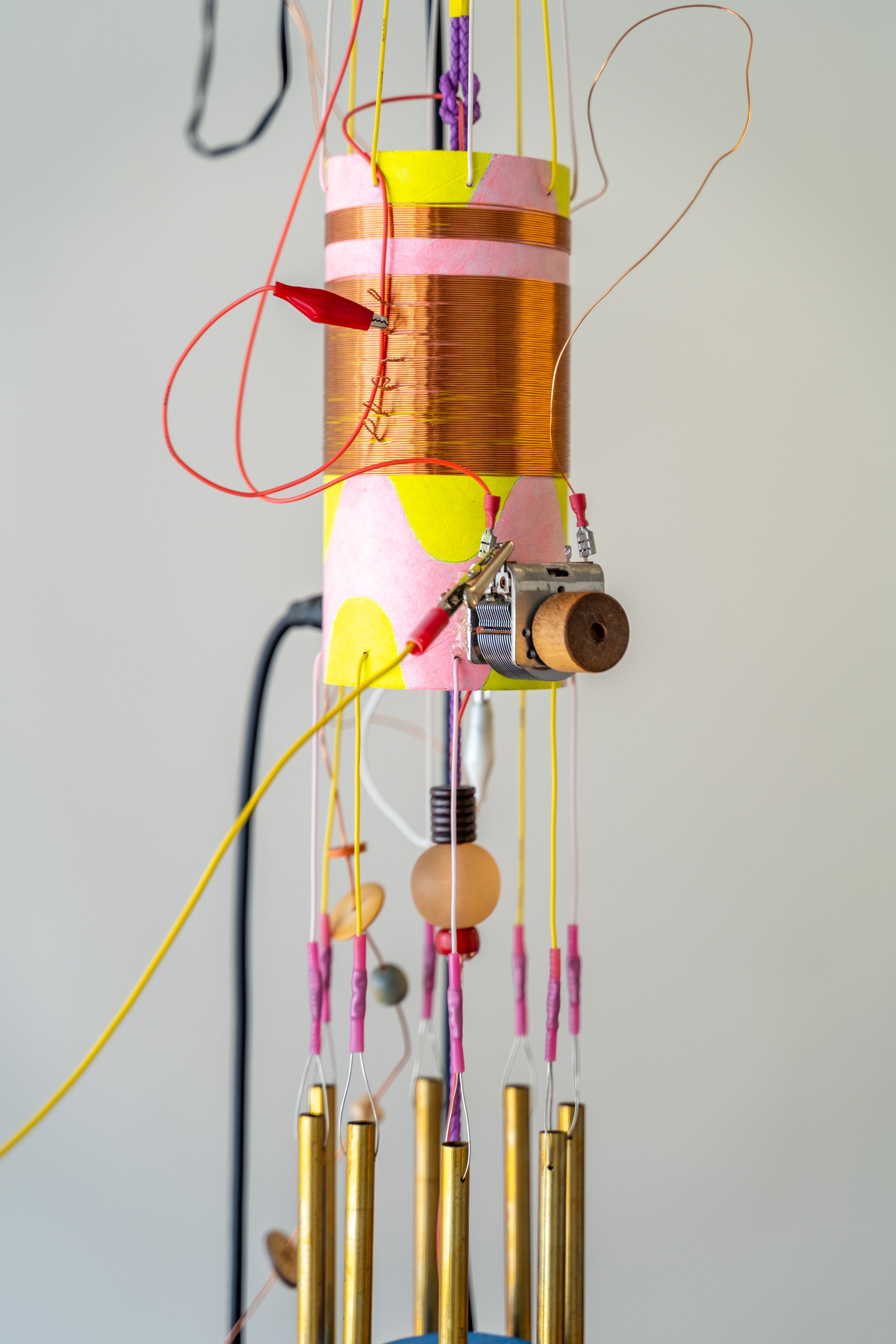  Peter Simensky  Pyrite Radio - Chimes (Yellow/Pink) , 2021 (detail) Pyrite (fool's gold), copper, electrical wires, bead work, feathers, cardboard tube, paint, amplifiers, and radio hardware 