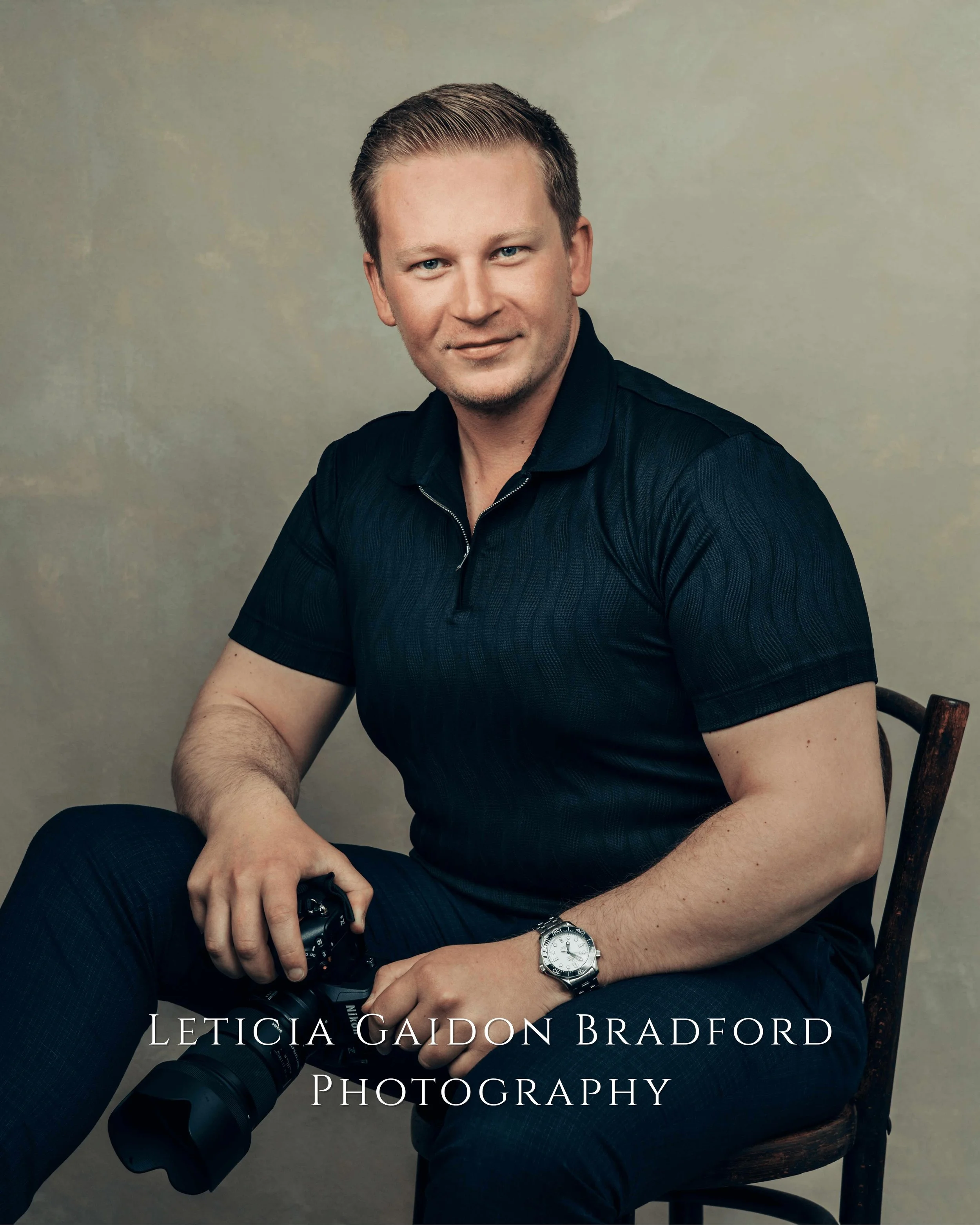 Man sitting holding a photograph camera. Aberdeen and Aberdeenshire photographer - Leticia Gaidon Bradford Photography - Corporate photos - Headshots - Personal Brand - Images for website - Blog