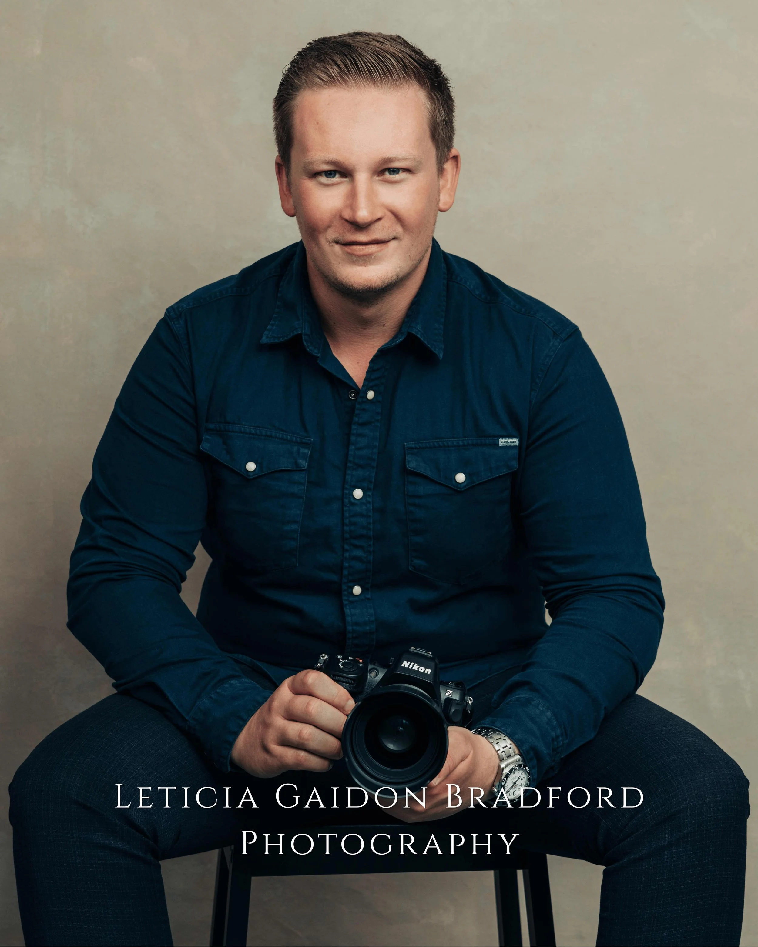 Man sitting holding a photograph camera. Aberdeen and Aberdeenshire photographer - Leticia Gaidon Bradford Photography - Corporate photos - Headshots - Personal Brand - Images for website - Blog