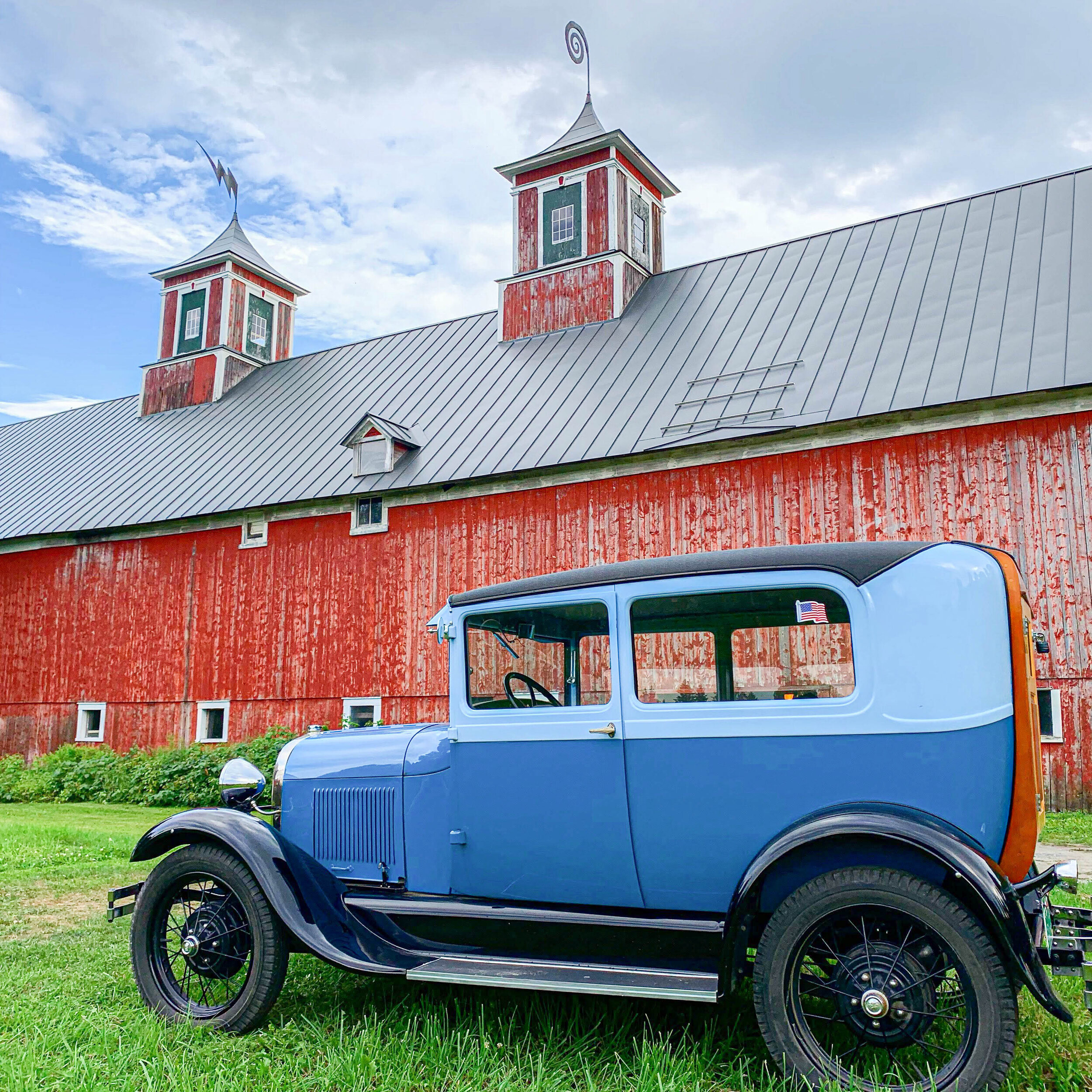 An antique car outside of the barn at Turning Stone Farm