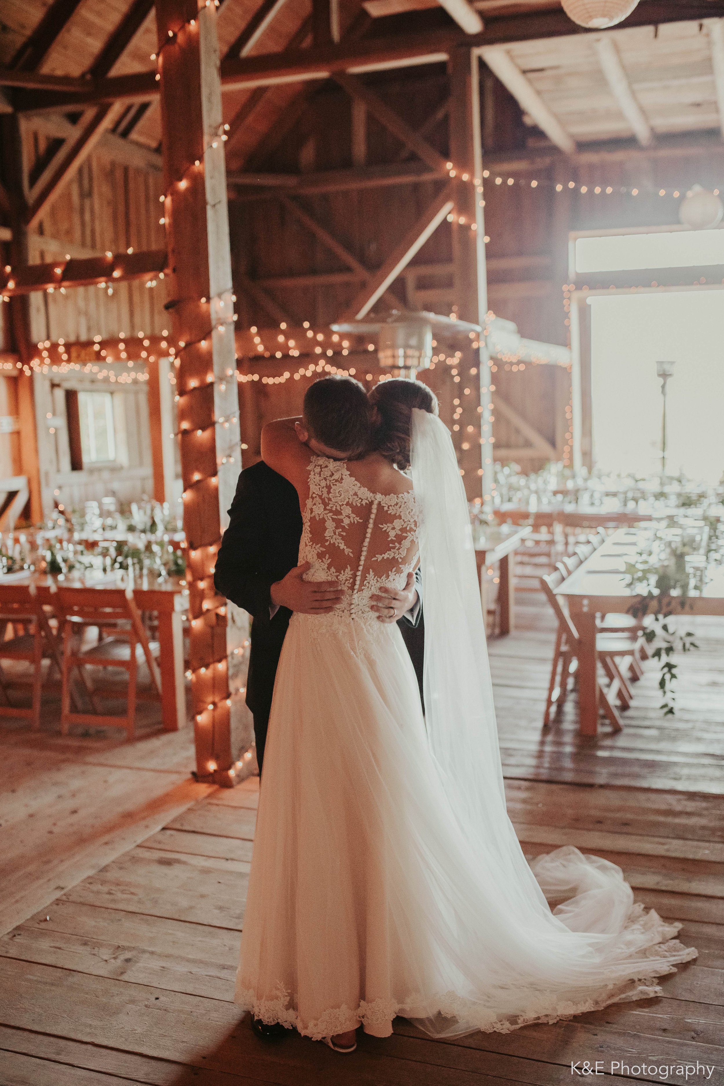 First wedding dance in the barn lit with twinkle lights