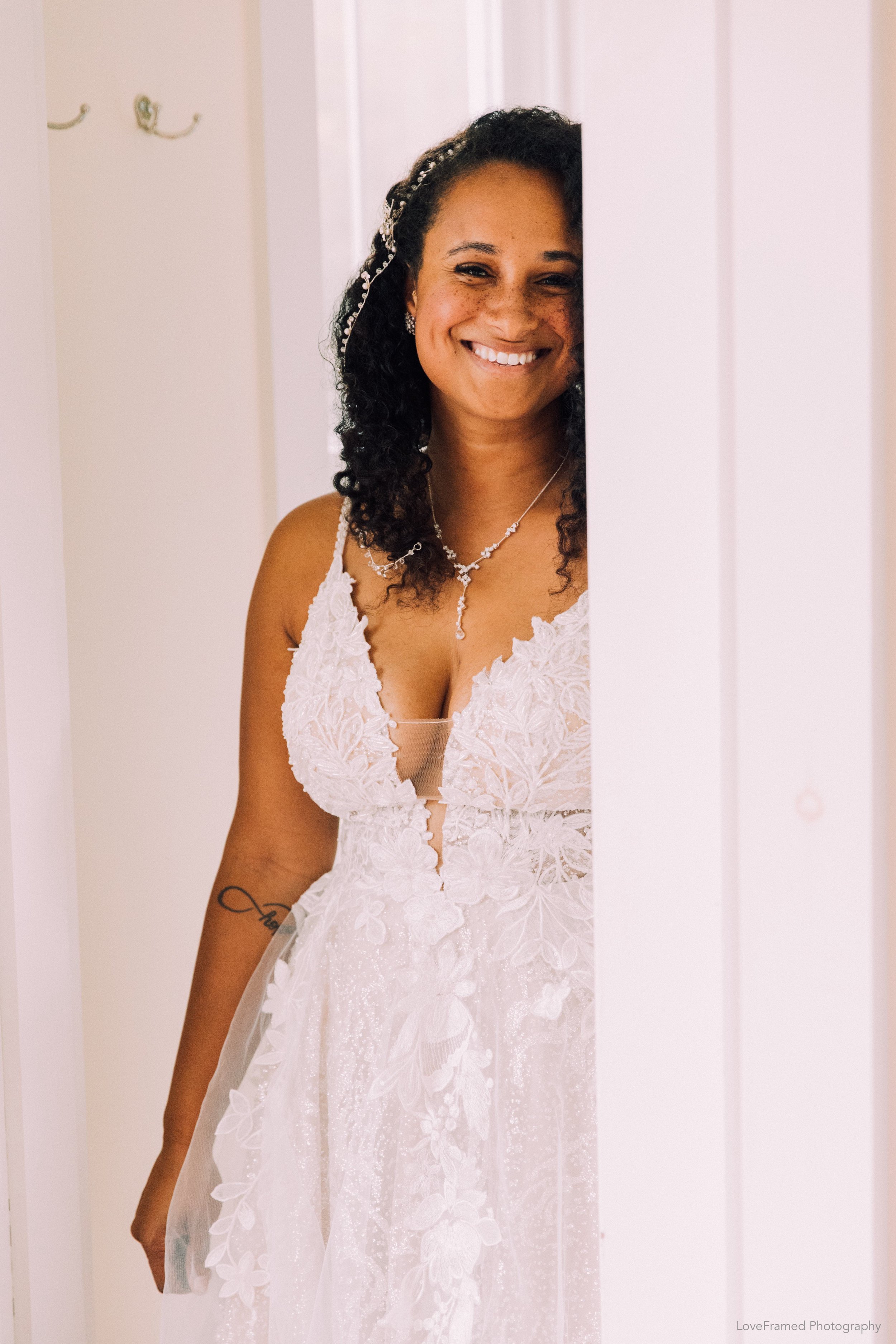 A bride standing in a room before her wedding