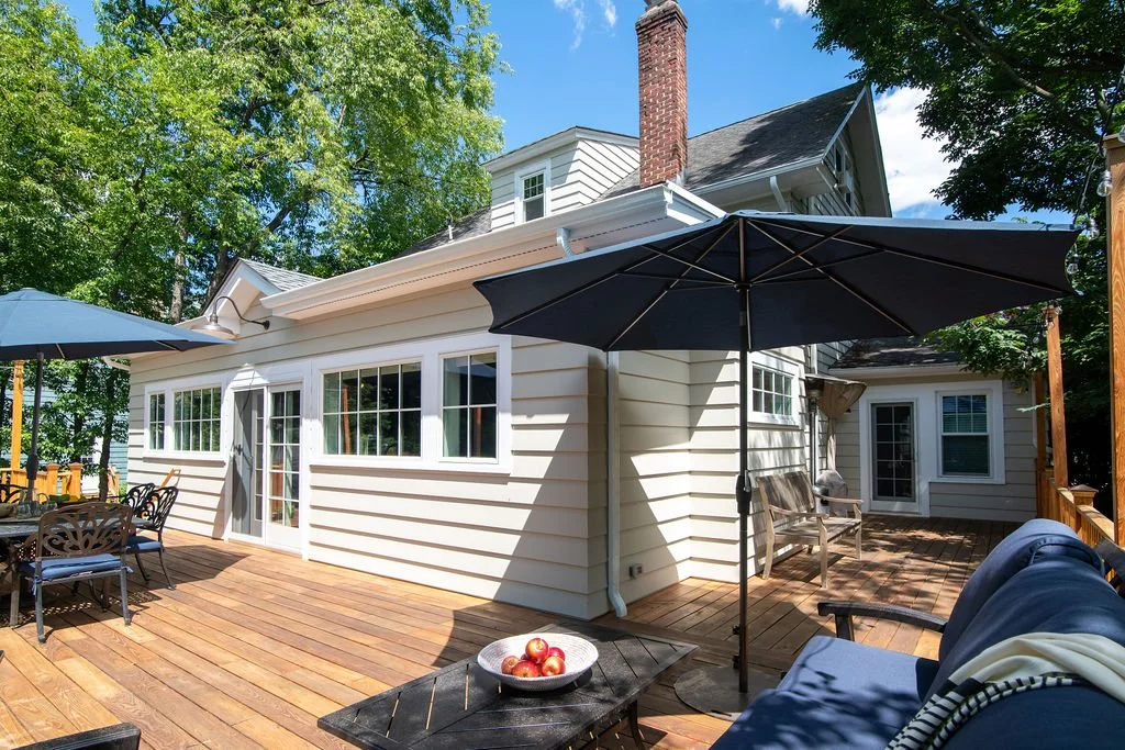   Exterior After:  The addition now houses the family's relocated kitchen and dining room, with a wraparound deck that connects to what was once a dining room and is now a dedicated home office. The goal from day one was to make this addition look li