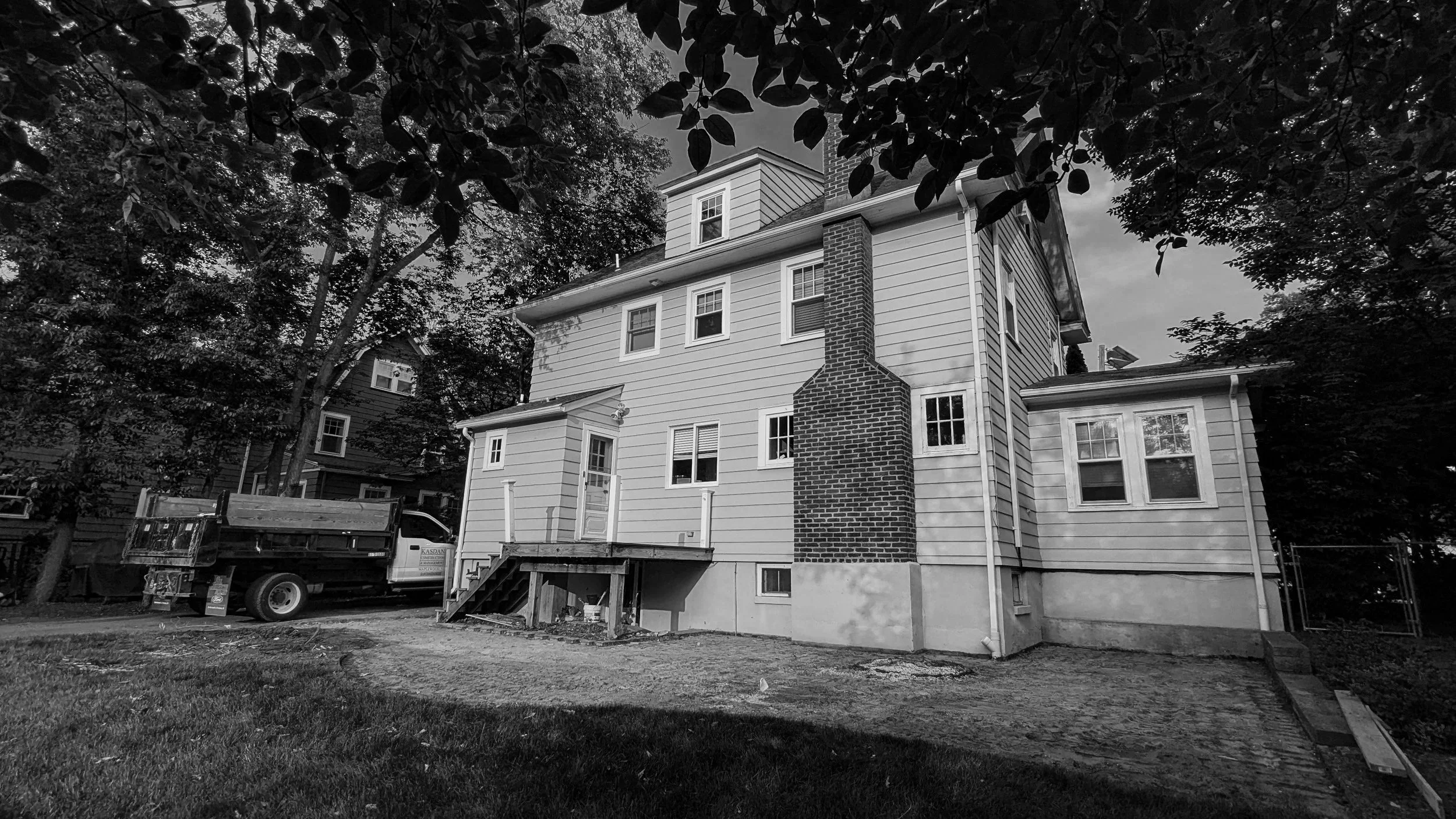   Exterior Before:  Before any work began, this was the back of a 100 year old home that no longer matched how the family wanted to live in it. What looks like a straightforward exterior hid a cramped kitchen and a dining room that had run its course