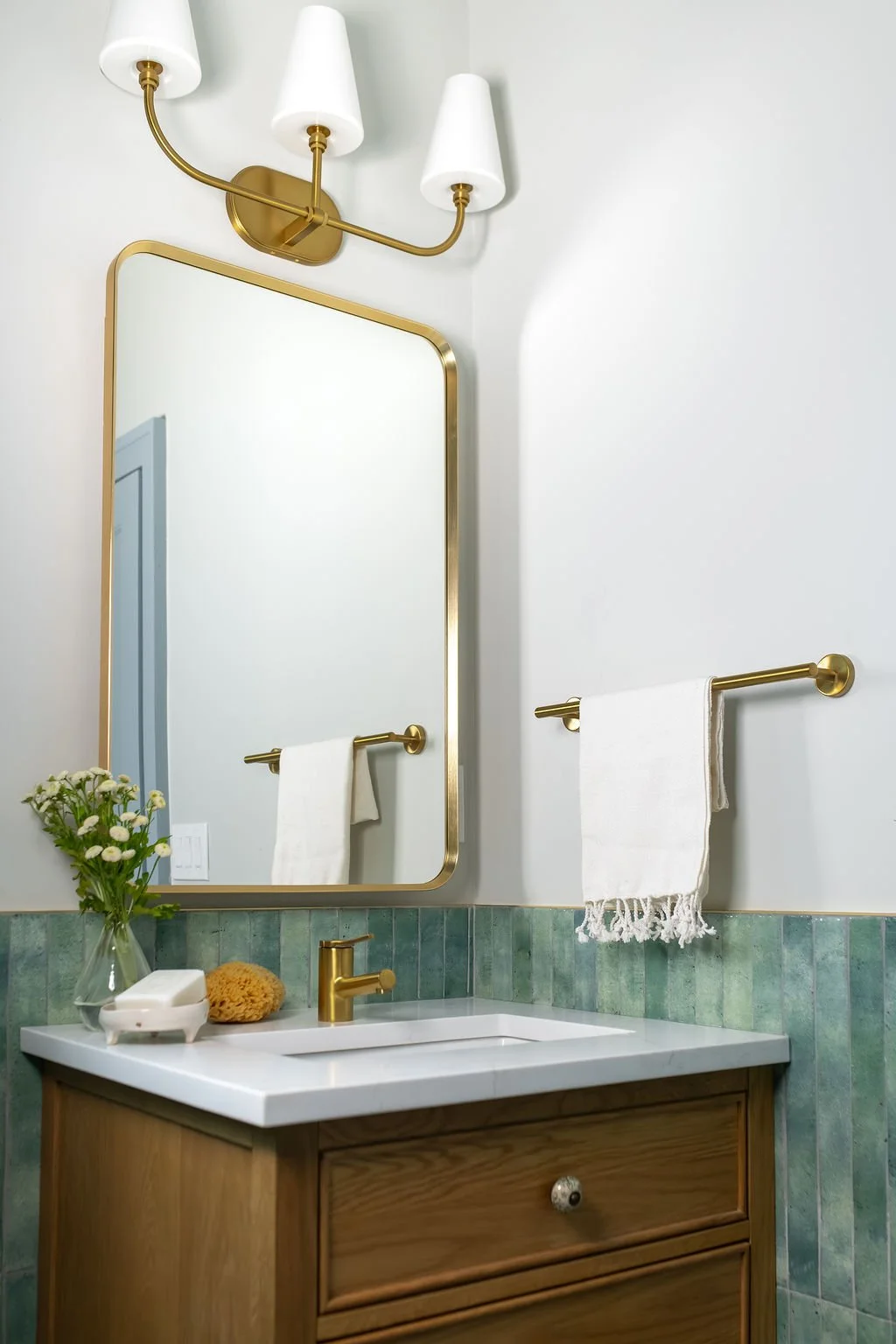   Ensuite Bathroom:  This ensuite bathroom now occupies part of what used to be the family's cramped kitchen, transformed into a space designed with gracious proportions and aging in place in mind, right down to the elegant grab bars ready for whenev