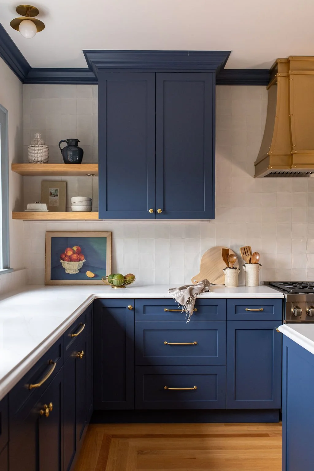  Kitchen Addition:  The family, kids included, helped choose the kitchen's blue cabinetry, and that same care carried down to the floor, where an accent wood species traces the room's perimeter and echoes the flooring found in every other room of th