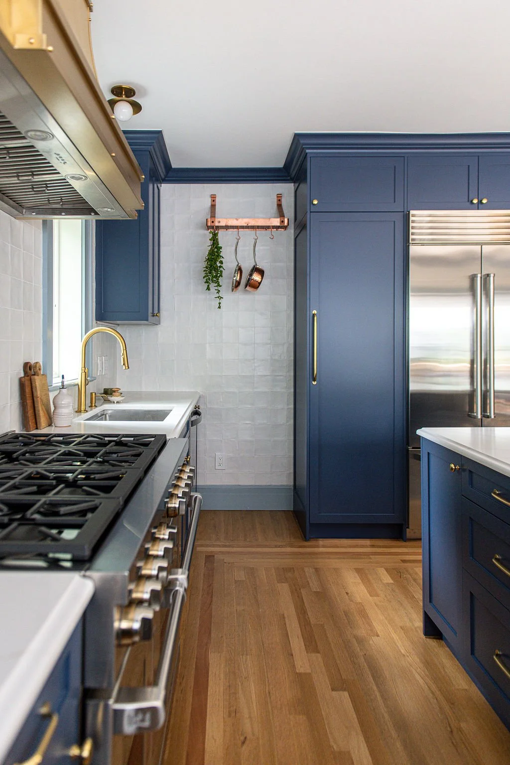 Tucked behind the pantry, the family's collection of pots and pans stays close at hand but out of view from the dining room, and there's a dedicated spot for the everyday clutter, from drying water bottles to the handheld vacuum. Finding a place for