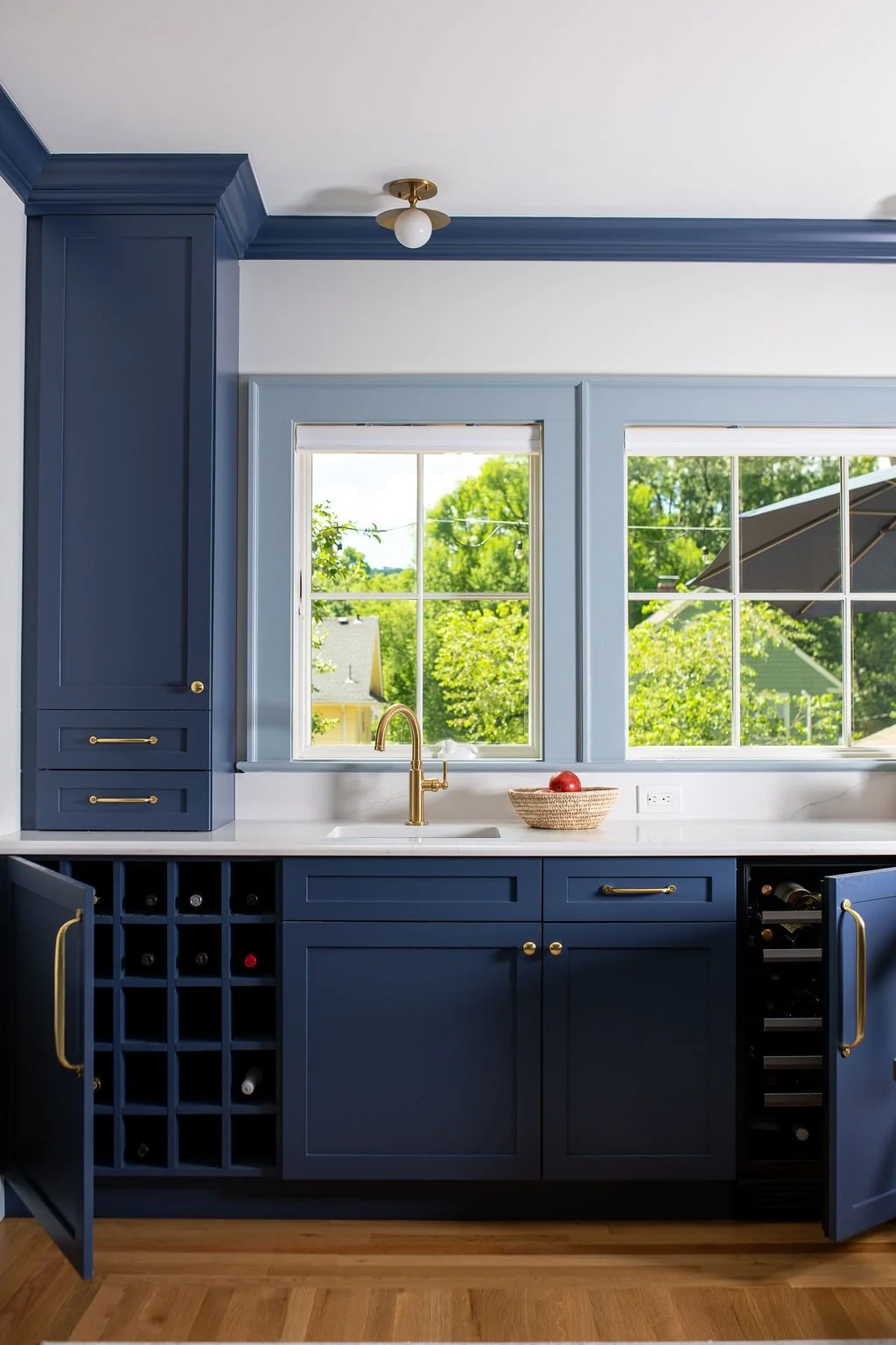  This coffee bar doubles as a wet bar for entertaining, with integrated storage for red wine on one side and a wine fridge for whites on the other. From here, the family looks out toward the neighborhood and the reservation beyond, the kind of view t