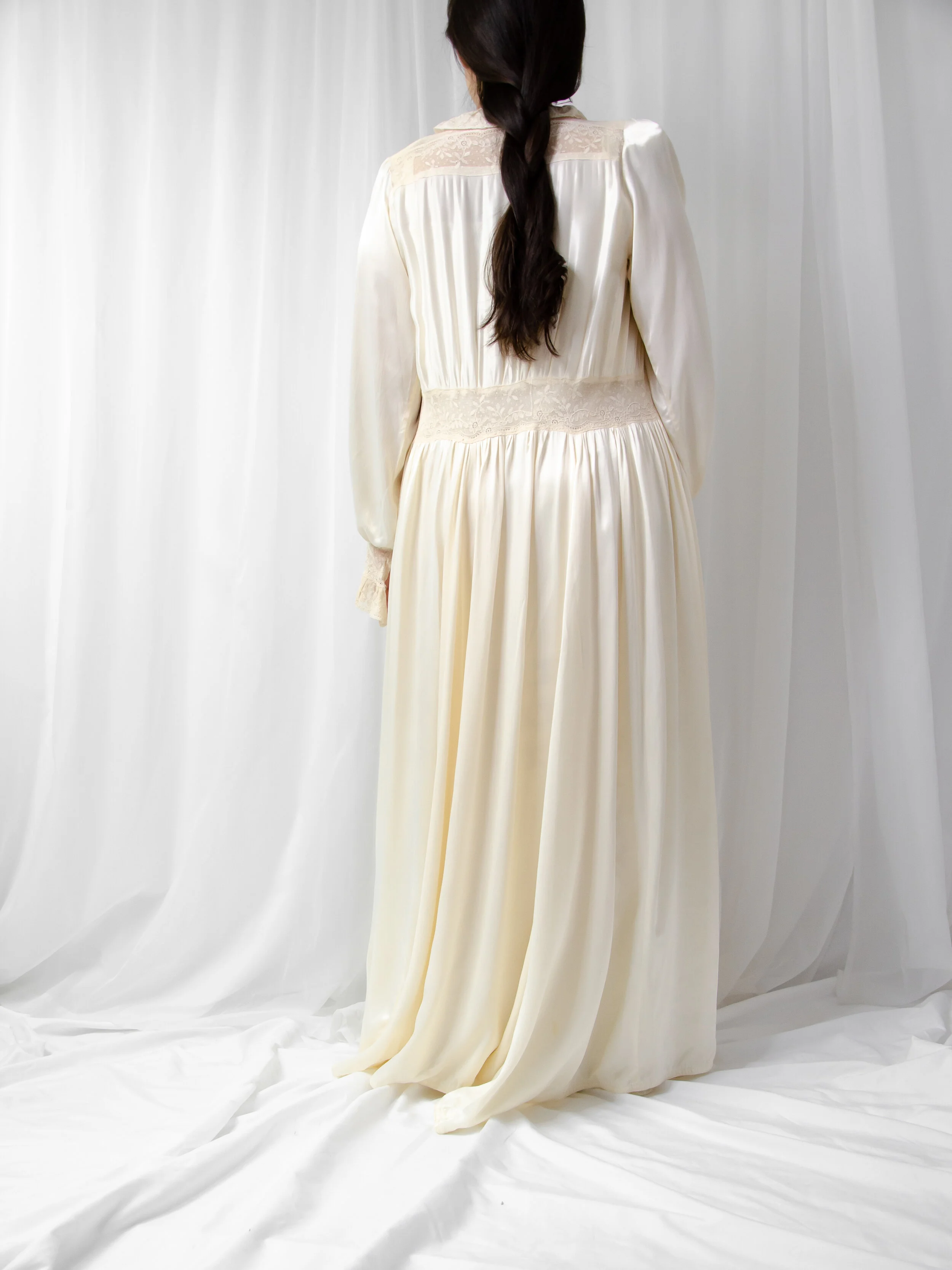 Back view of the 1940s eggshell satin bridal robe on a model, showing the full gathered skirt.