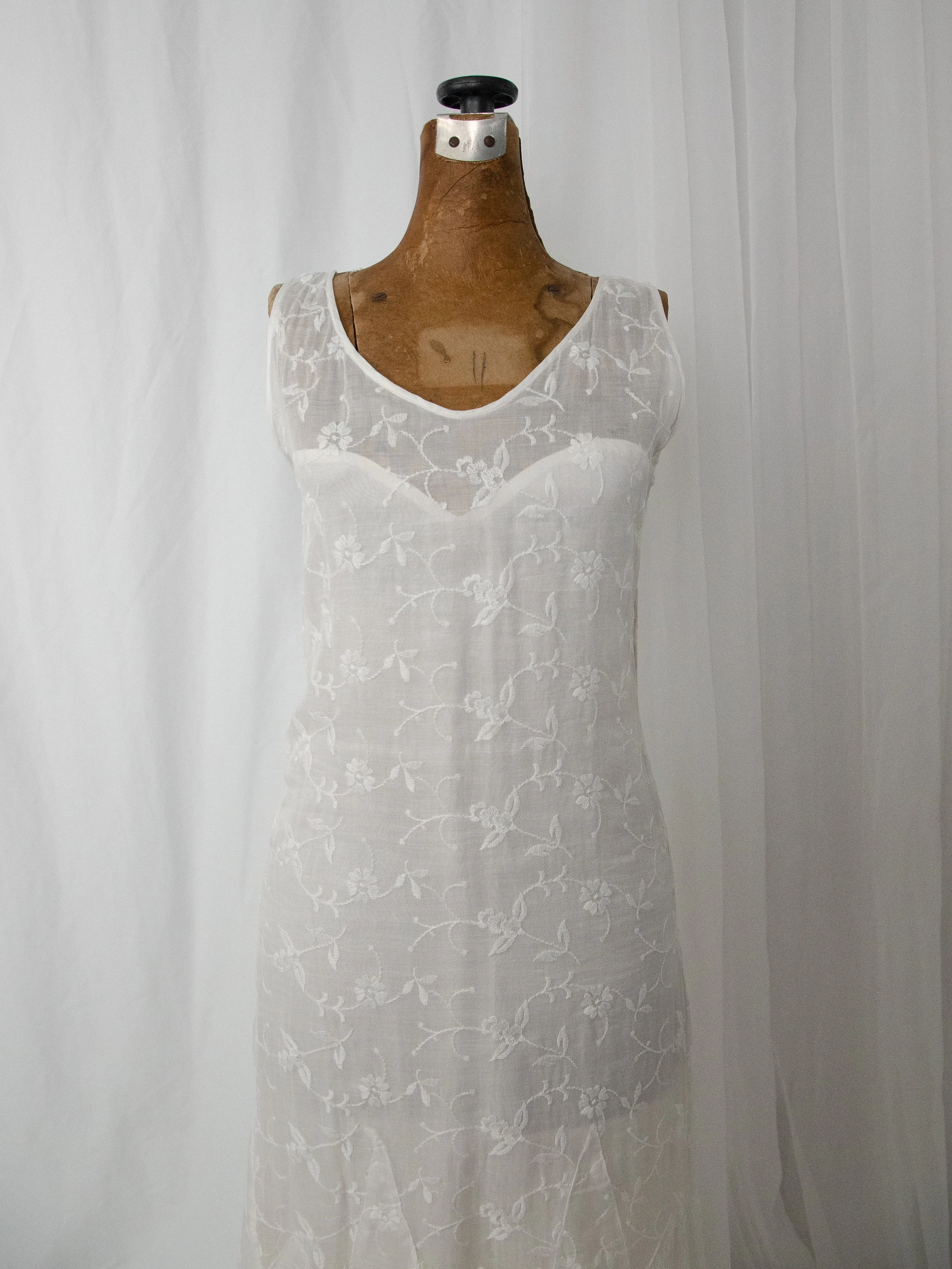 Close-up of the 1930s organdy dress bodice on a dress form, showing the sheer sweetheart illusion neckline.