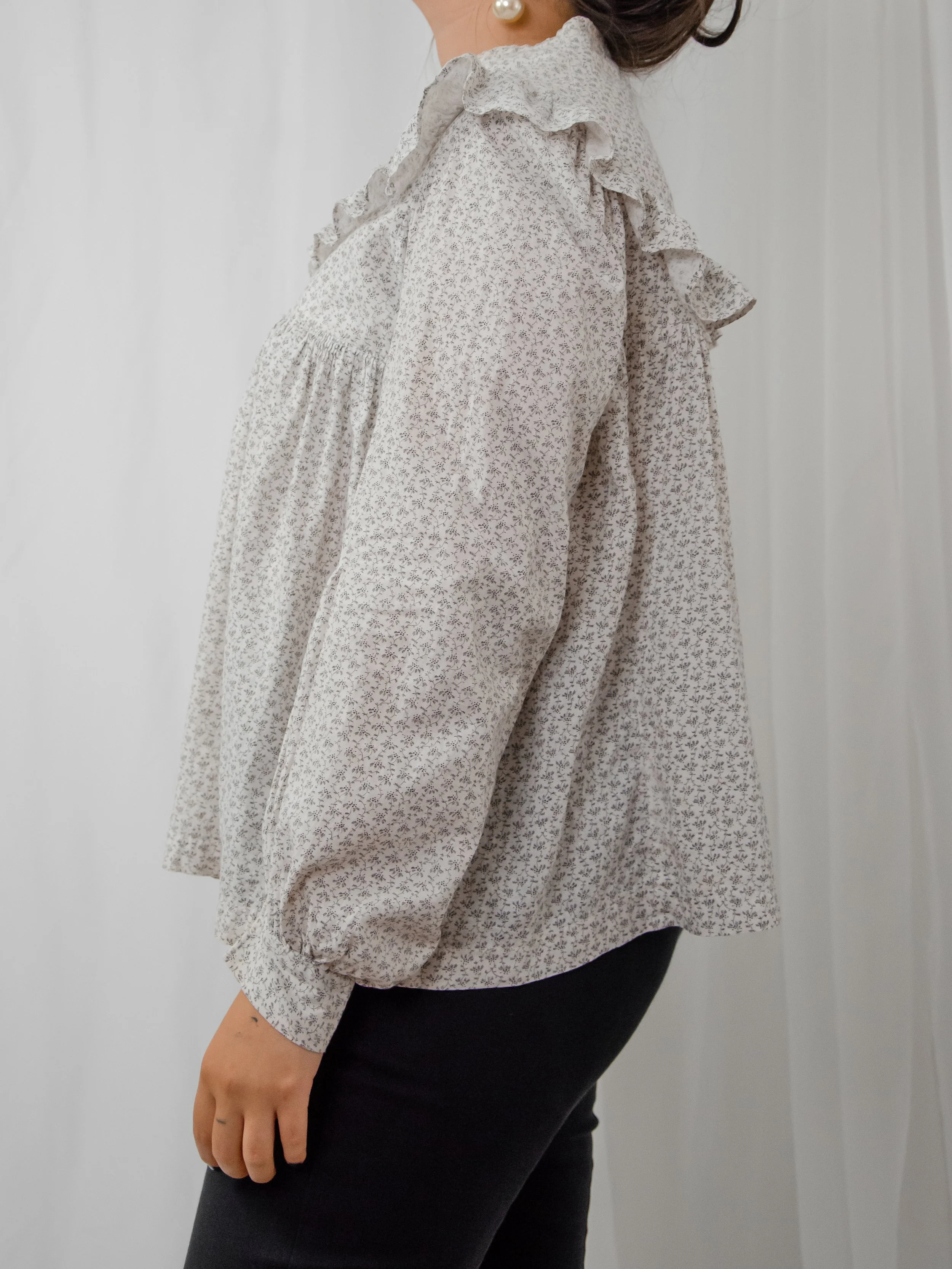 Side view of the Victorian calico prairie top on a model, showing the full bishop sleeve.