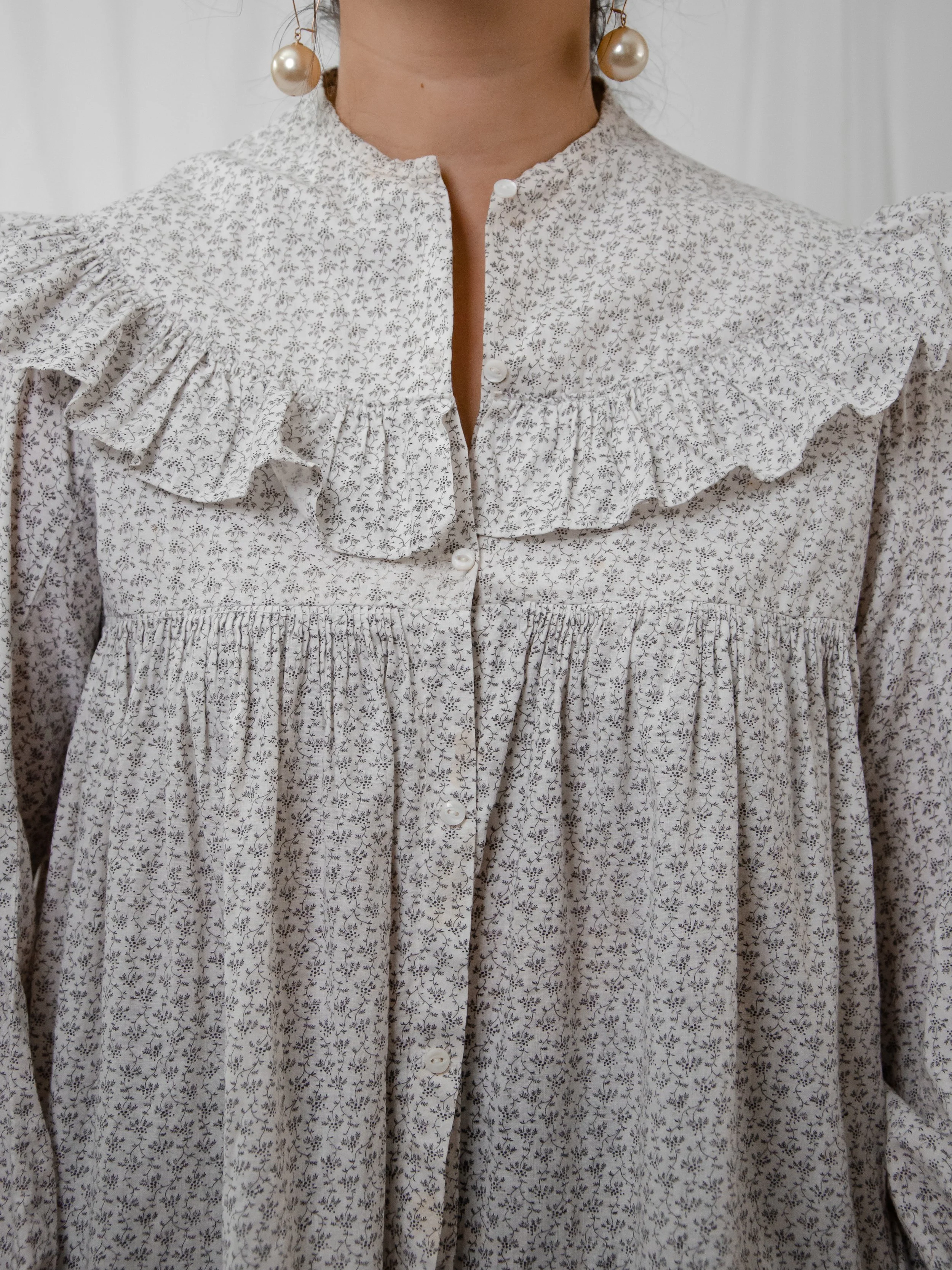 Close-up of the Victorian calico top's ruffled yoke, stand collar and button front.