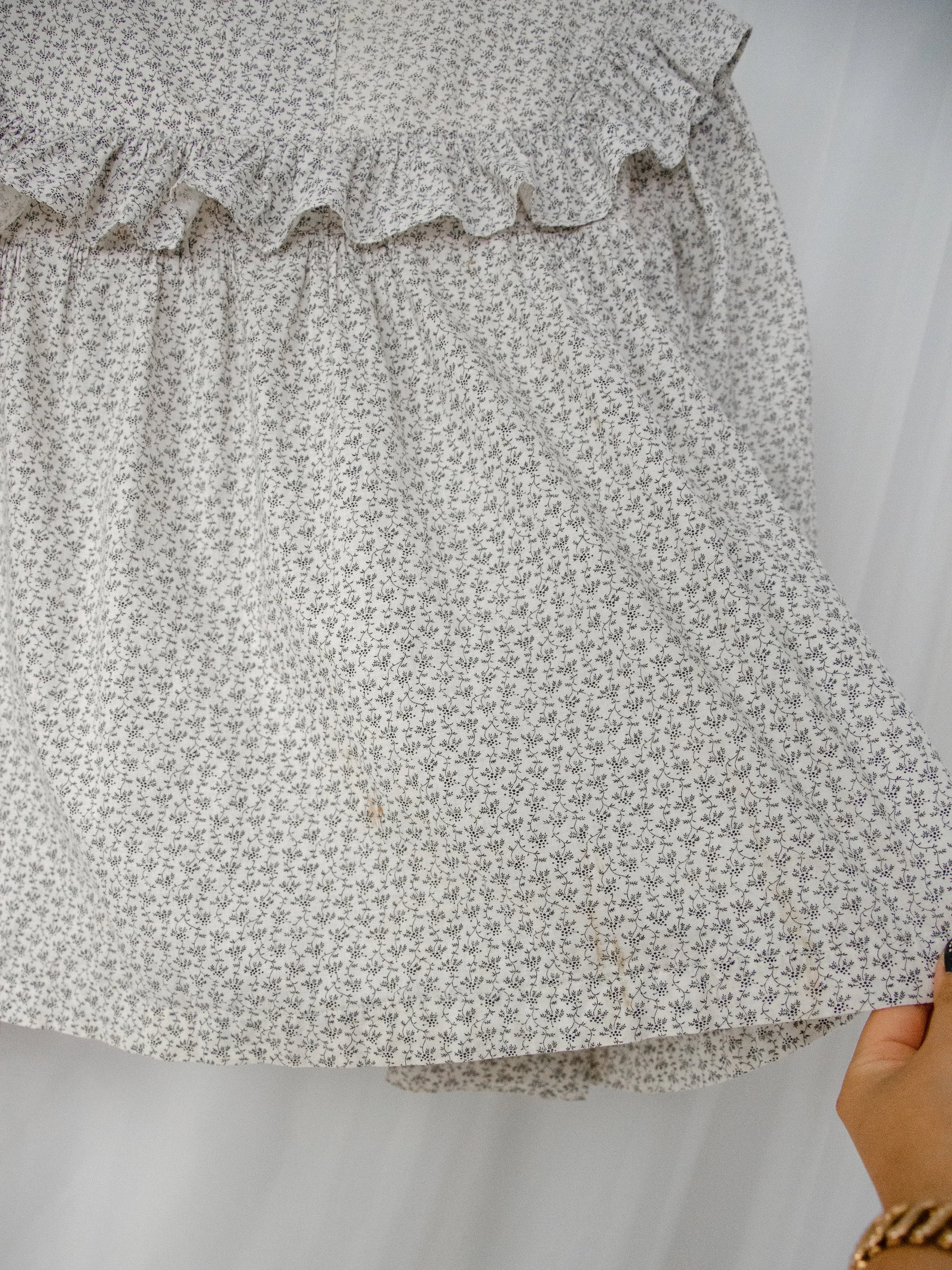 Detail of the Victorian calico top's gathered body and ruffle, showing faint spots of discoloration near the hem.