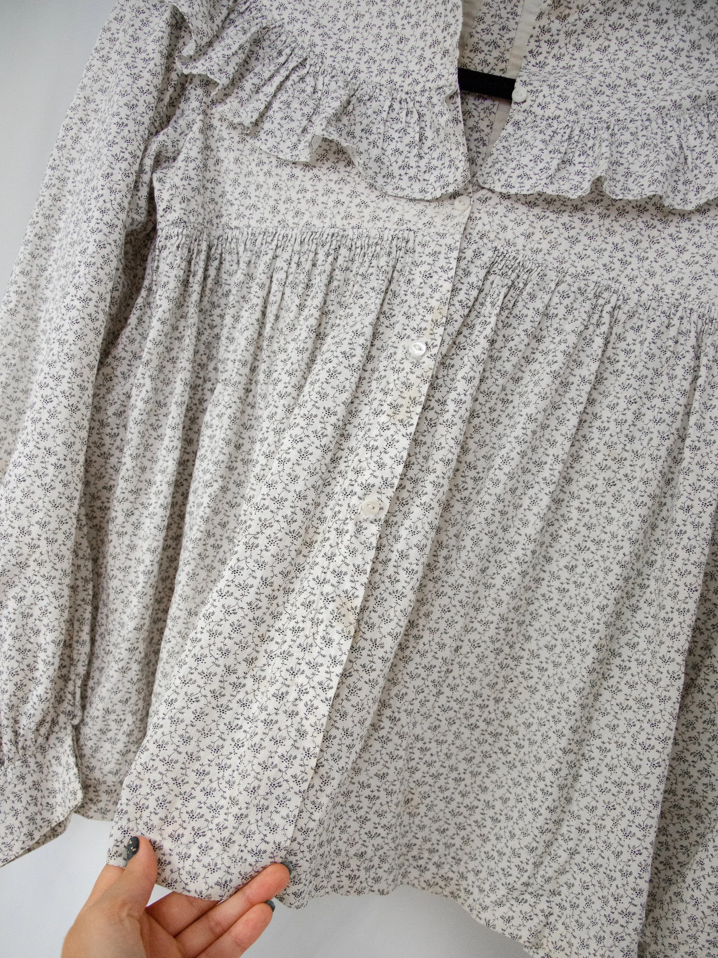 Close-up of the Victorian calico prairie top's button placket and gathered front below the ruffle.