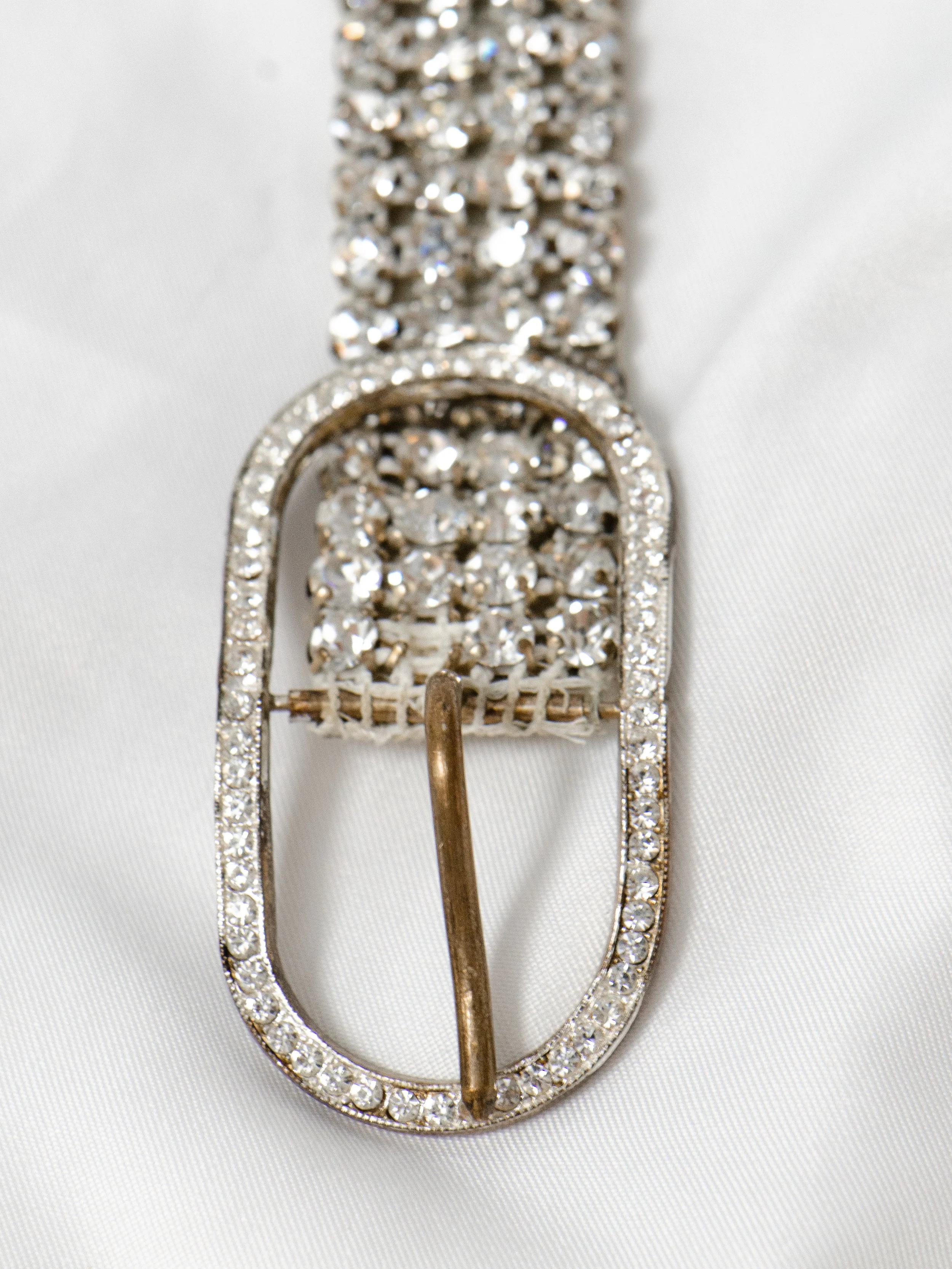 Close-up of the 1950s Austrian crystal belt's oval rhinestone buckle and prong.