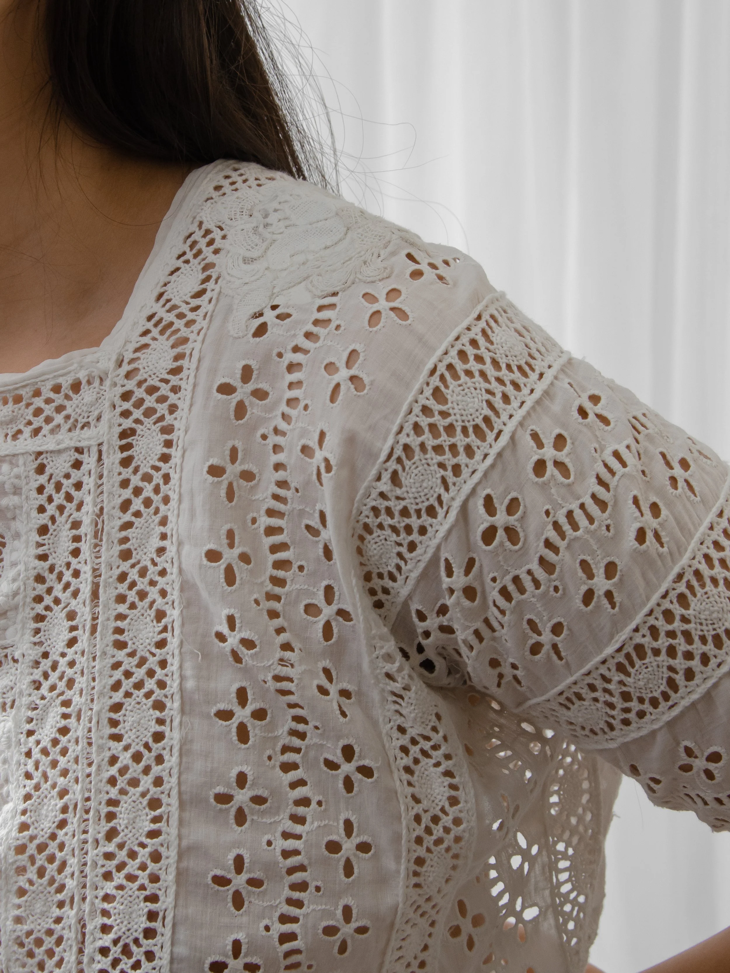 Detail of the Edwardian eyelet top's half sleeve, showing the crochet lace and floral eyelet pattern.