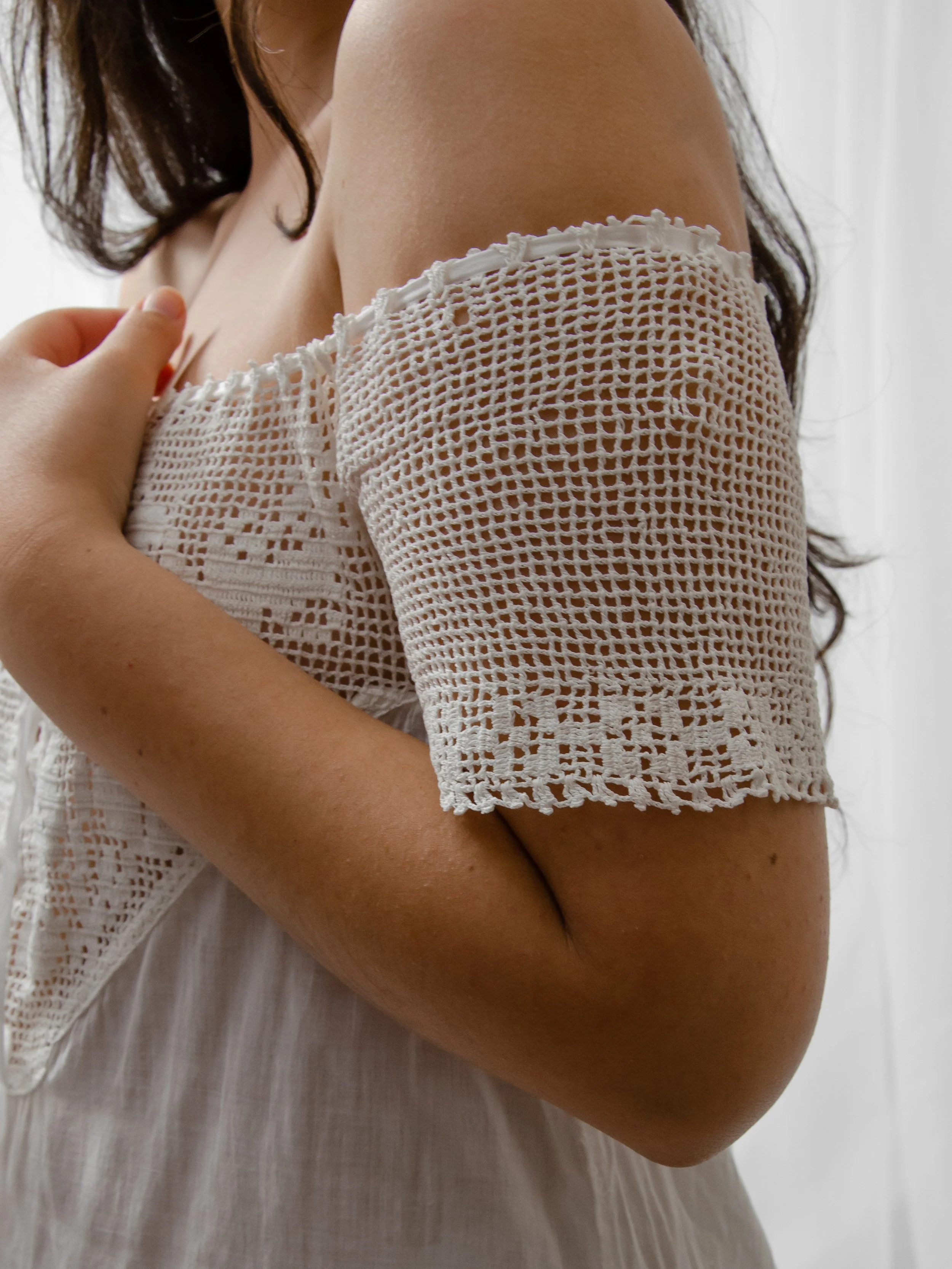 Close-up of the Edwardian off-shoulder dress's crochet sleeve with floral border.
