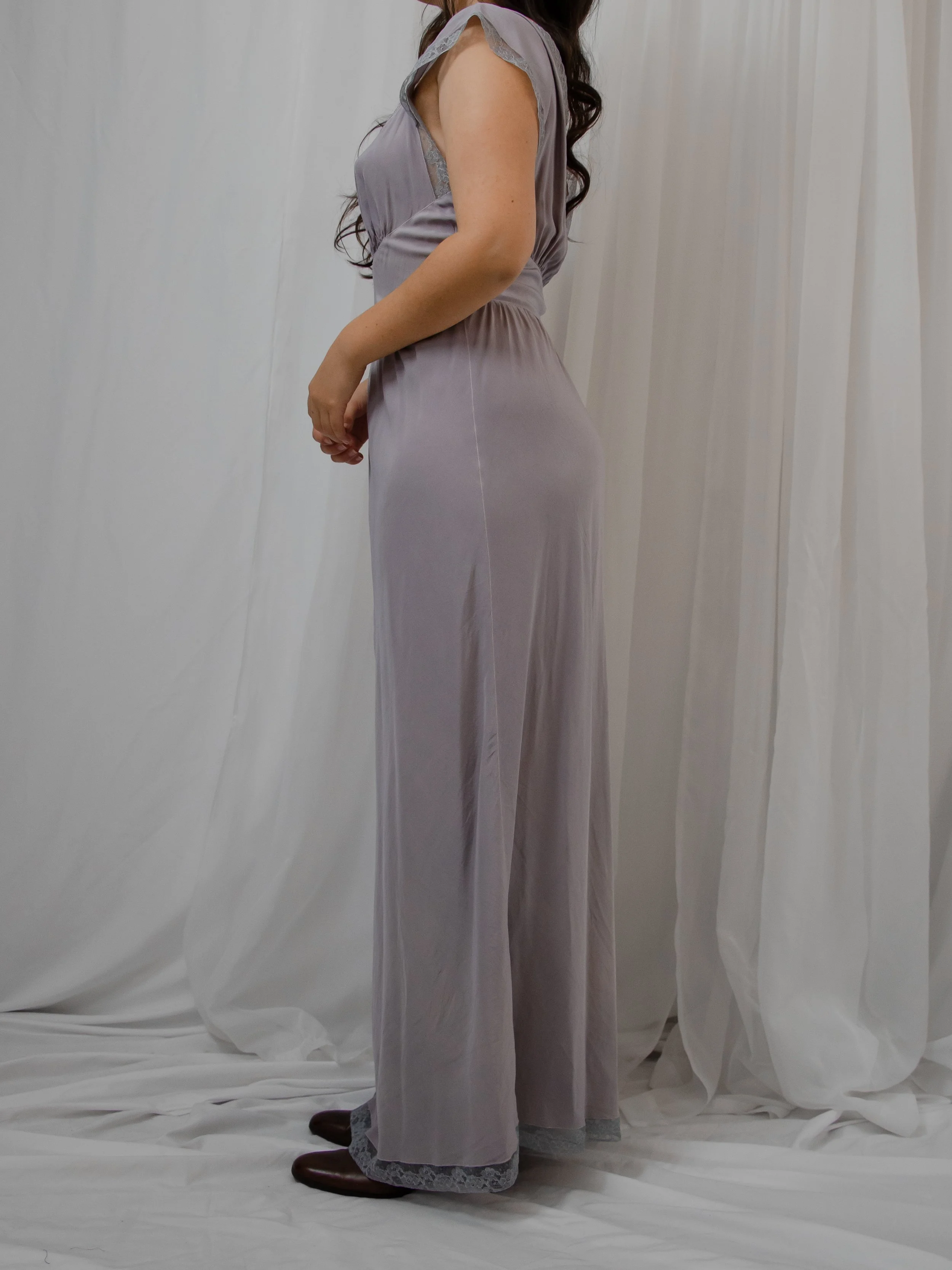 Side view of the 1940s dusty lavender silk dress on a model, showing the full-length silhouette.