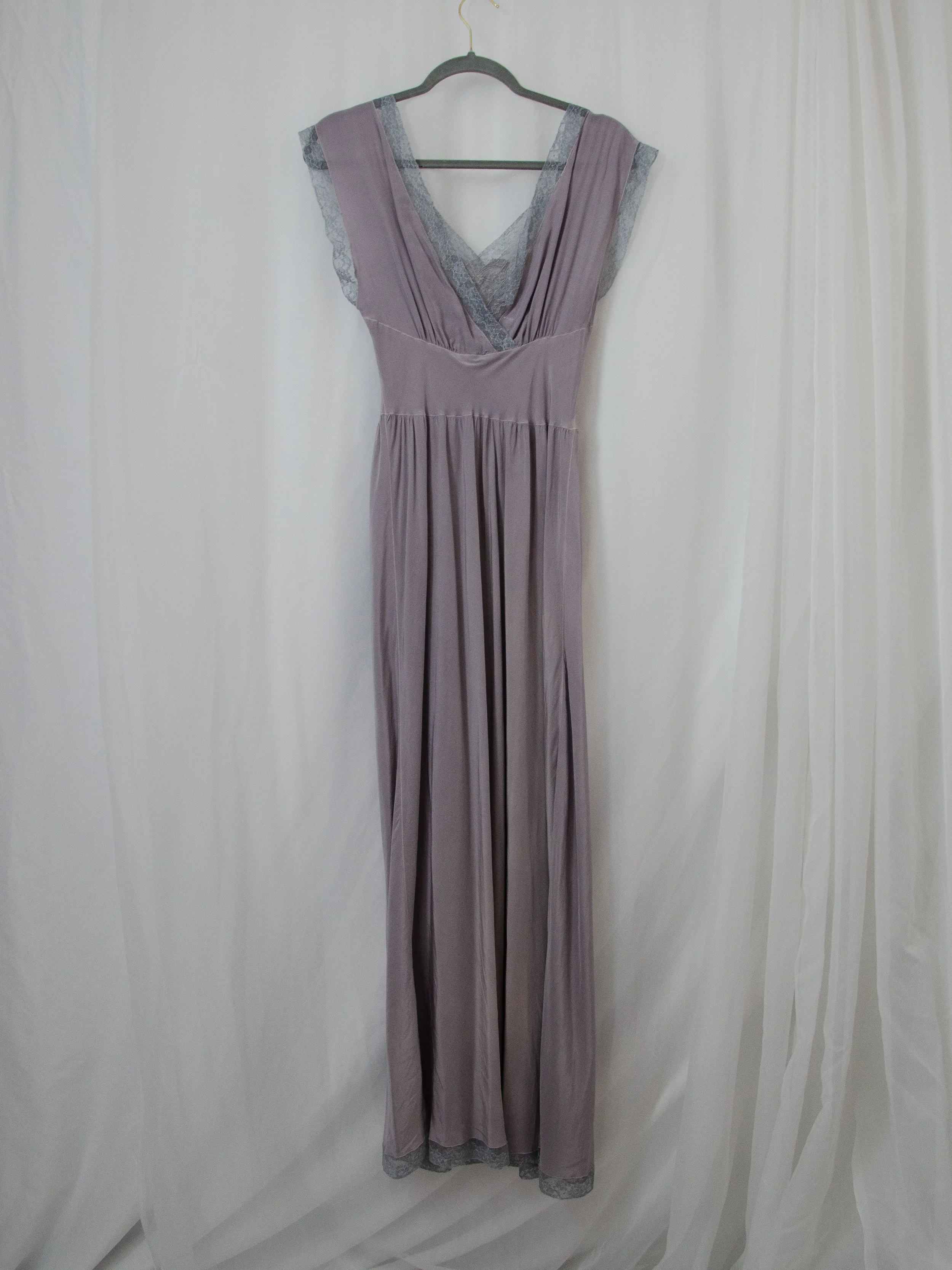 1940s dusty lavender silk dress on a hanger, full-length front view.