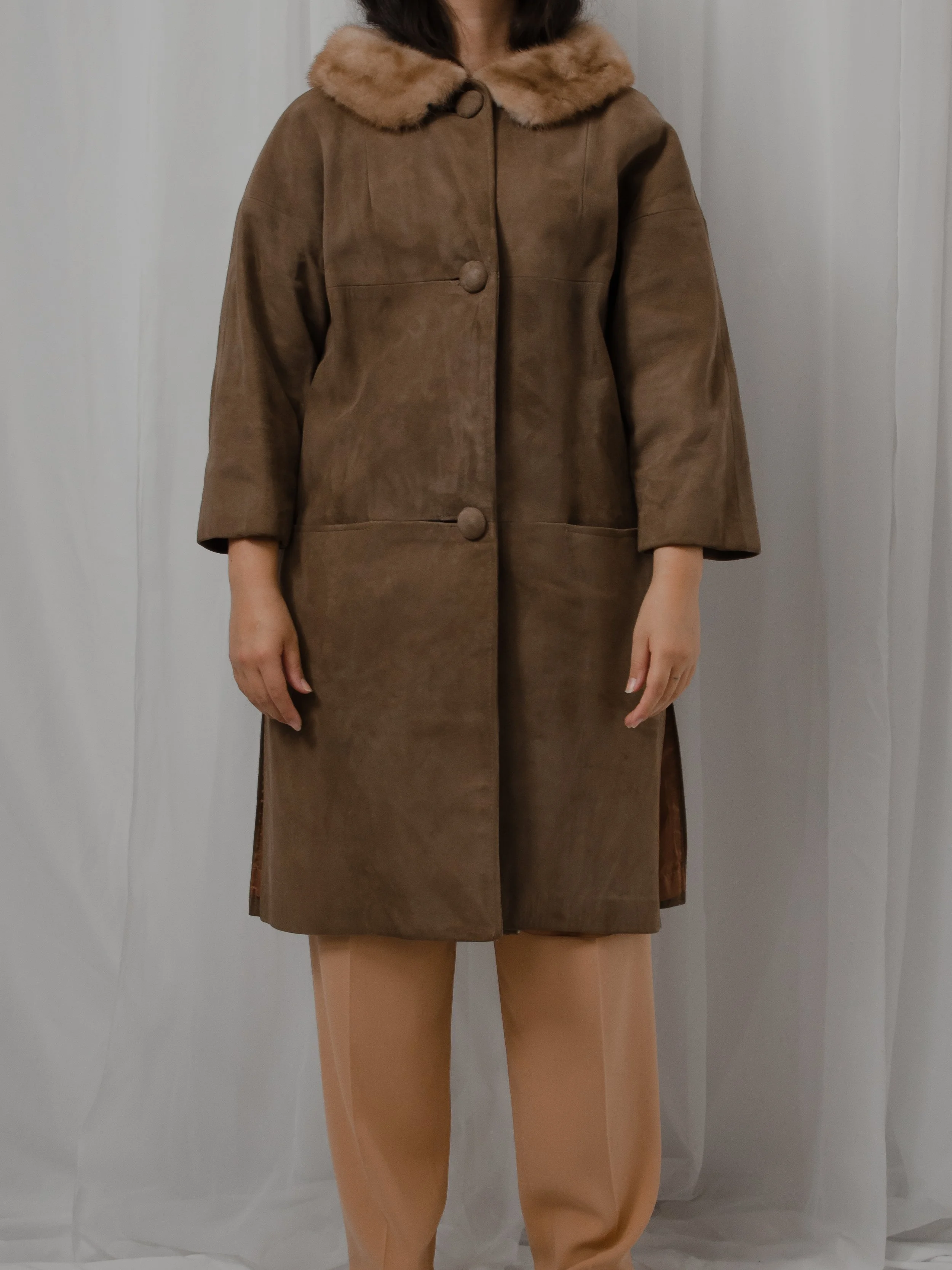 Front view of the 1940s chocolate brown suede coat buttoned on a model, showing the patch pockets.