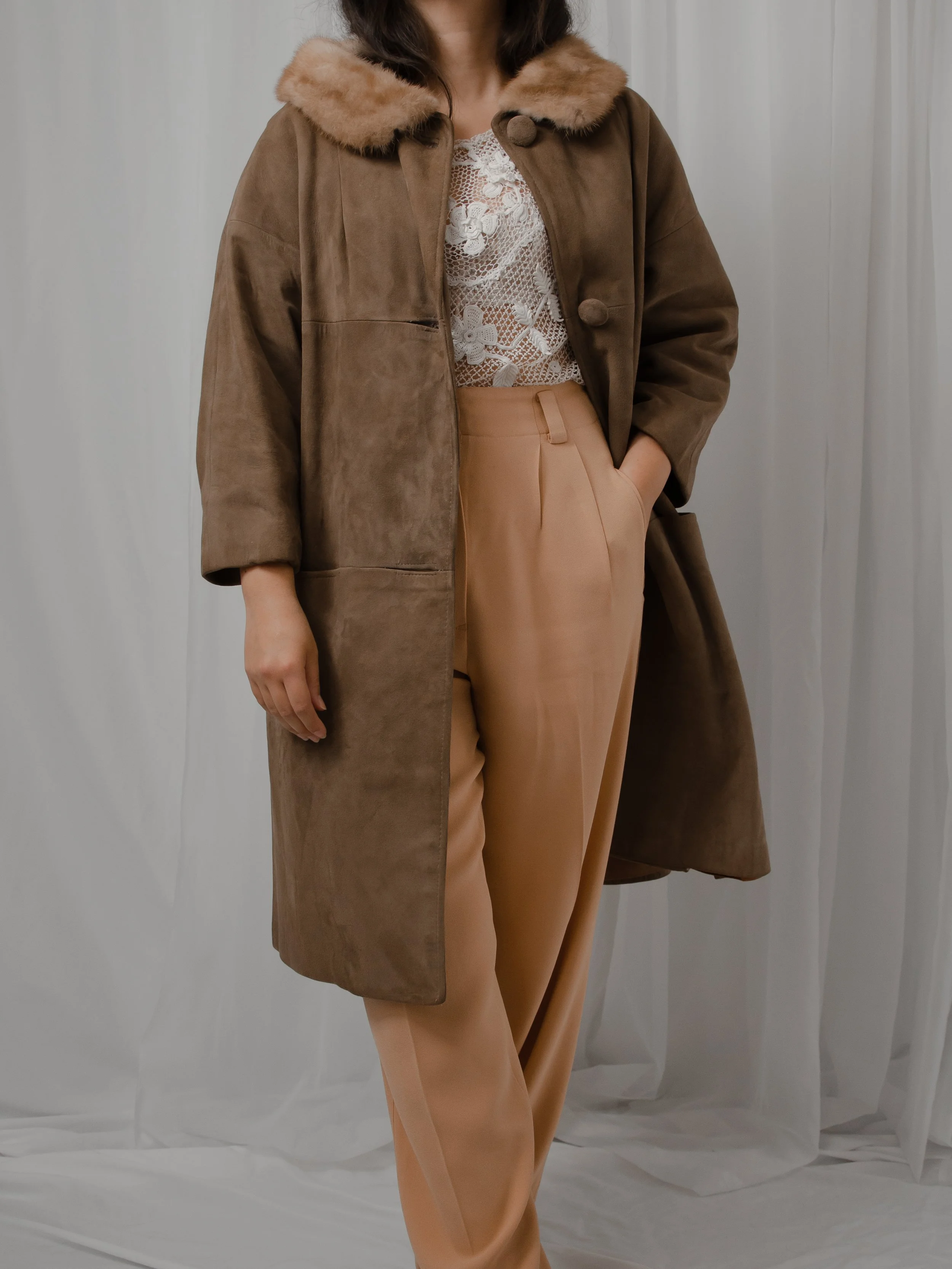 1940s chocolate brown suede coat with honey mink fur collar, worn open on a model with tan trousers.