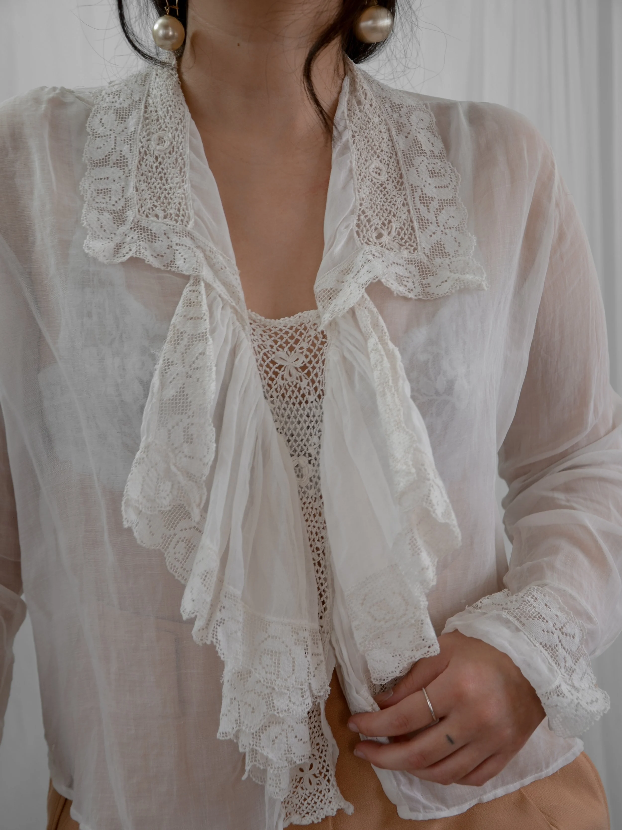 Close-up of the late Edwardian sheer blouse's Irish crochet and filet lace collar and front ruffle.